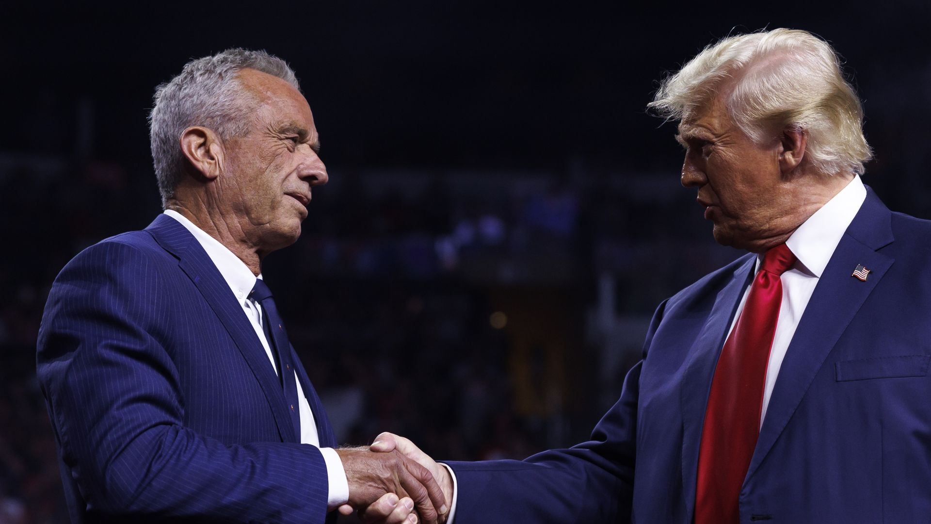 GLENDALE, AZ, AUGUST 23: Republican presidential nominee Donald Trump is greeted by Robert F. Kennedy Jr. on stage during a campaign event at Desert Diamond Arena in Glendale, Arizona, on August 23, 2024. Kennedy announced the suspension of his presidential campaign and would endorse Trump. (Photo b