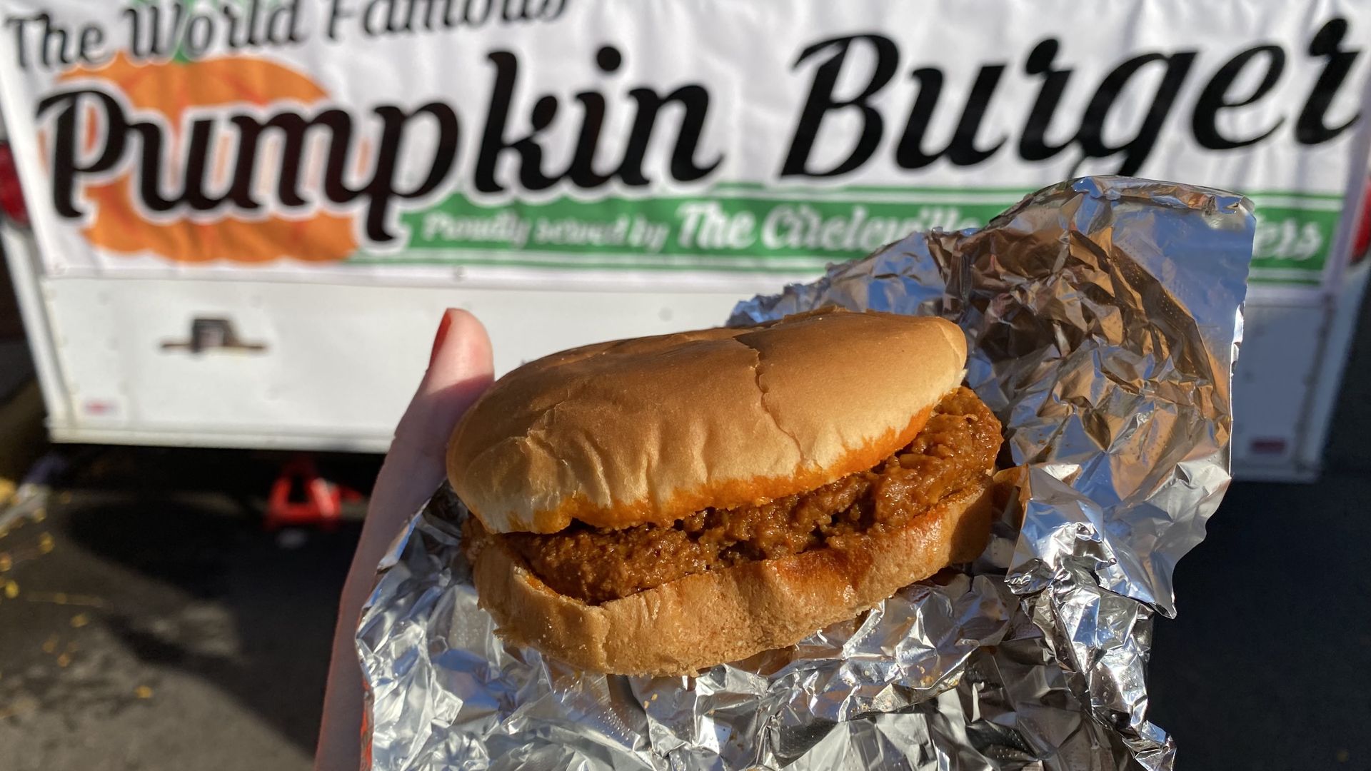 A close-up of a pumpkin burger sandwich on a piece of foil