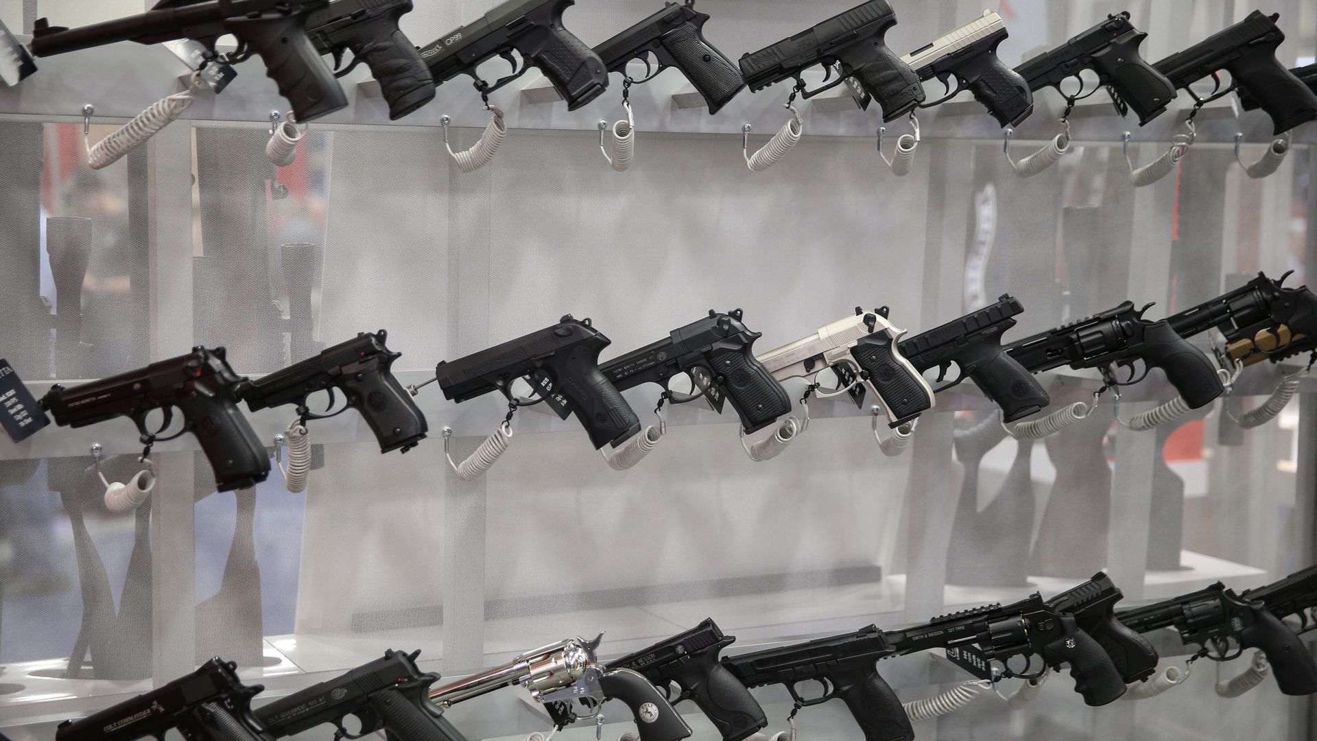 Rows of hand guns on shelves.