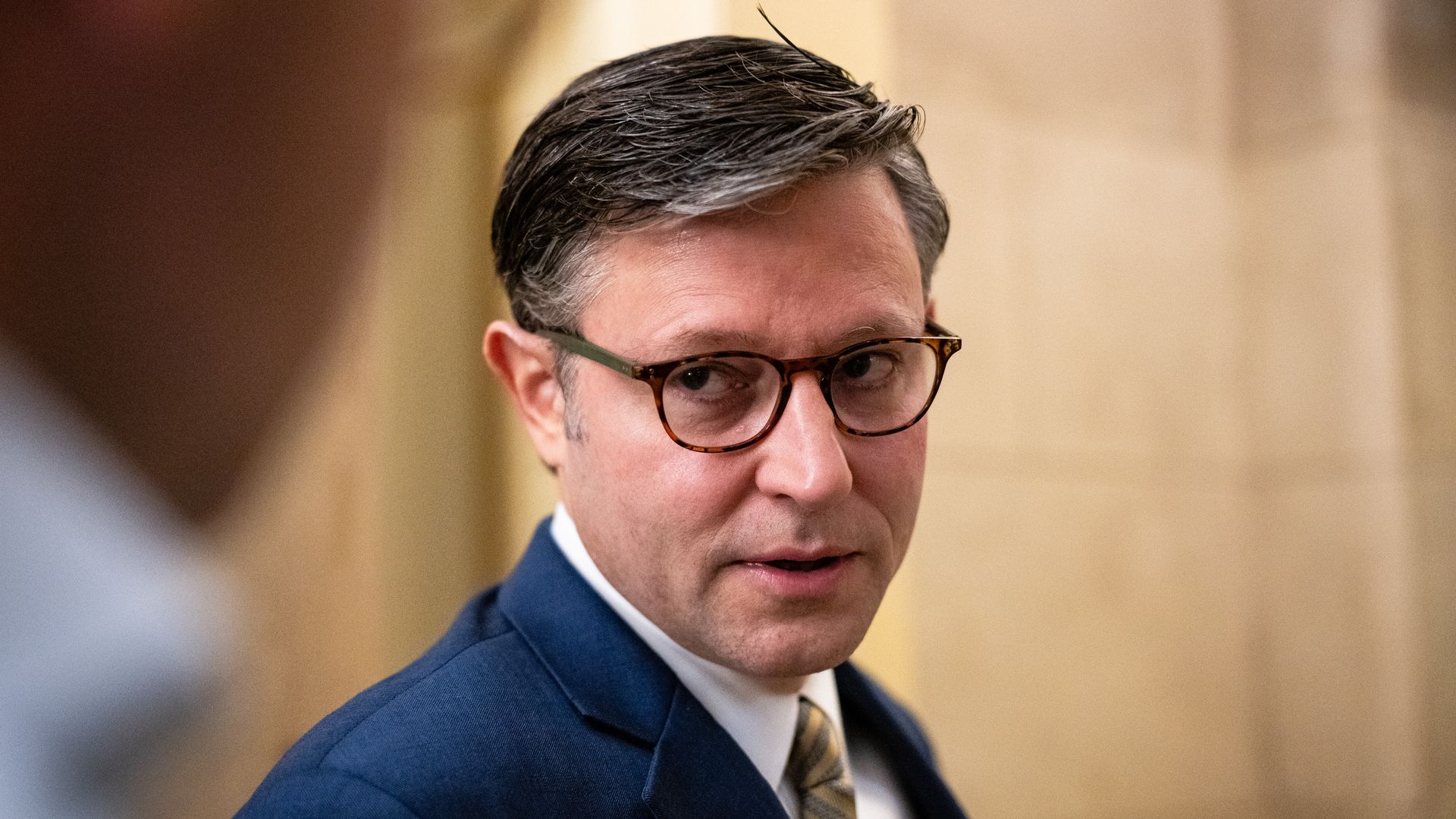 A close-up of Mike Johnson speaking to reporters.