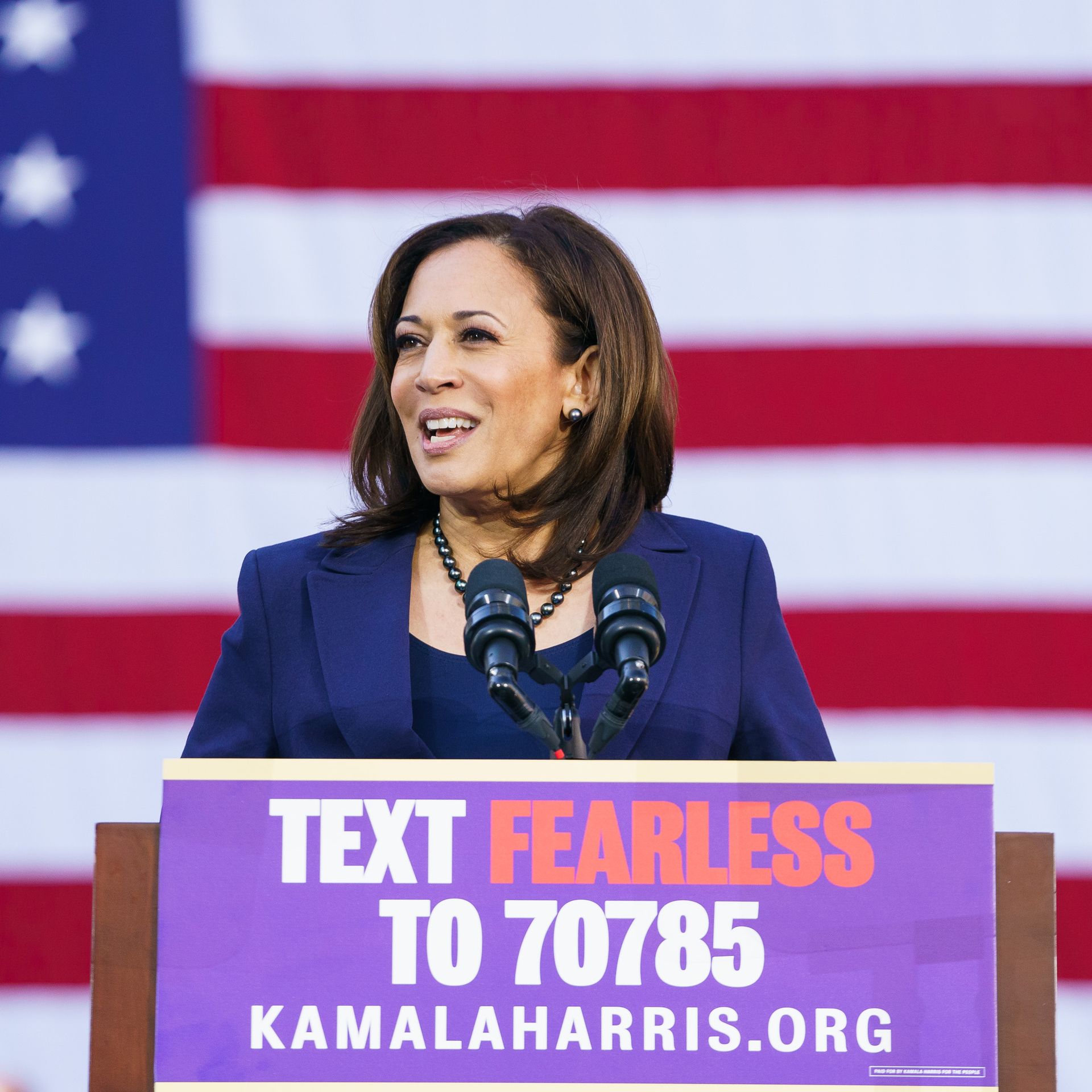 Kamala Harris behind a podium at her campaign announcement