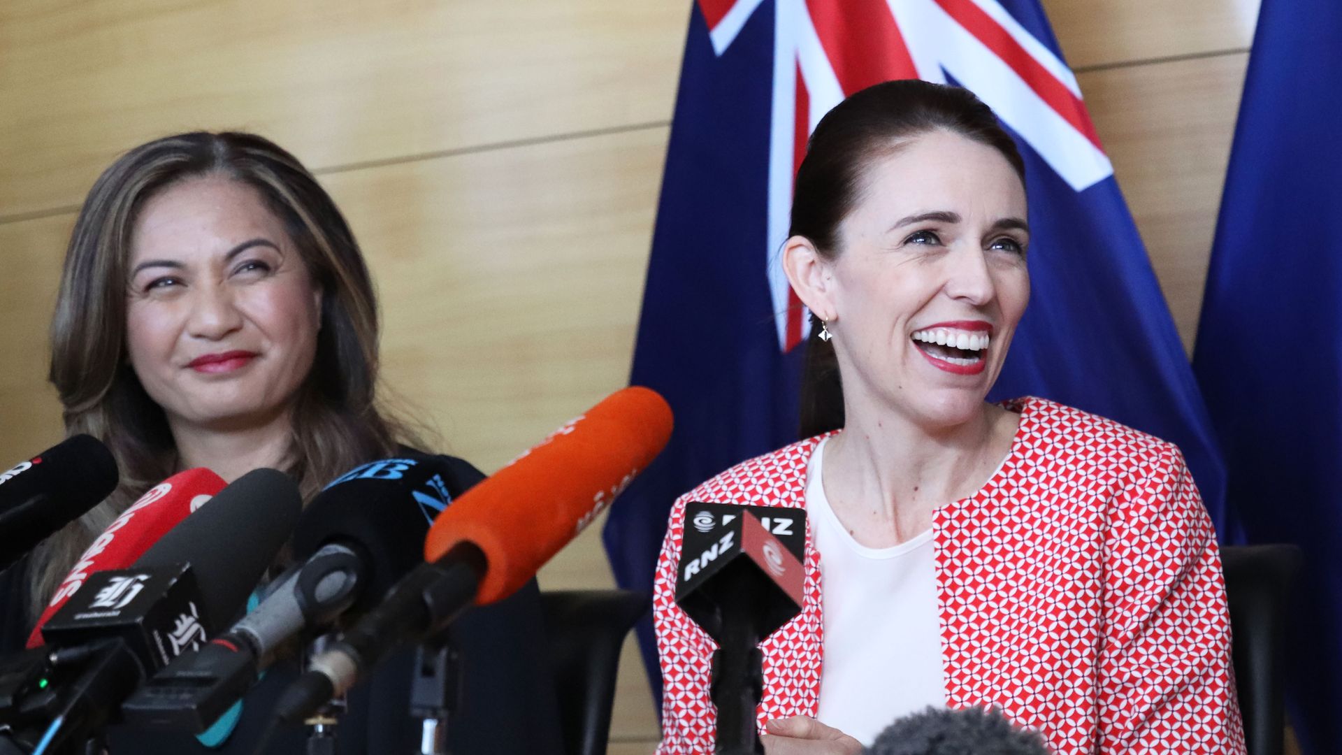 New Zealand Labour leader (and re-elected Prime Minister) Jacinda Ardern, seated next to Green Party co-leader Marama Davidson, smiles after signing a co-operation agreement on November 01 local time