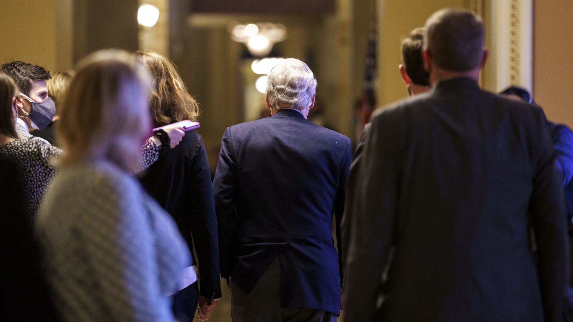 Senate Minority Leader Mitch McConnell is seen walking away from the Senate Chamber.