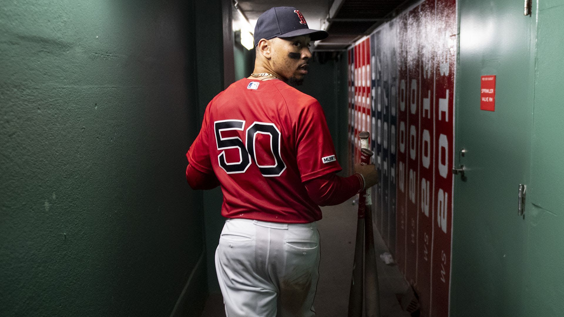 Mookie Betts walks through a Fenway Park tunnel 