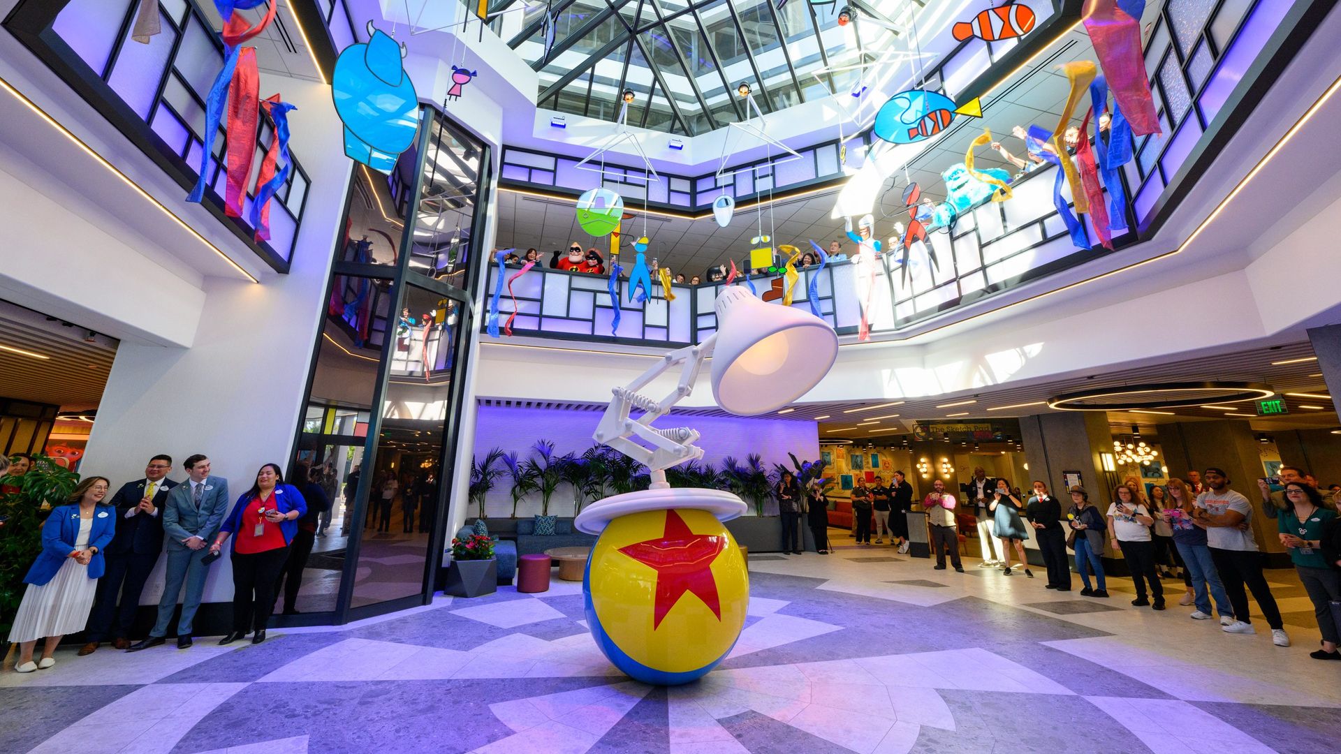 Photo of the interior of the new Pixar Place Hotel, which features a life-sized model of the Pixar lamp logo