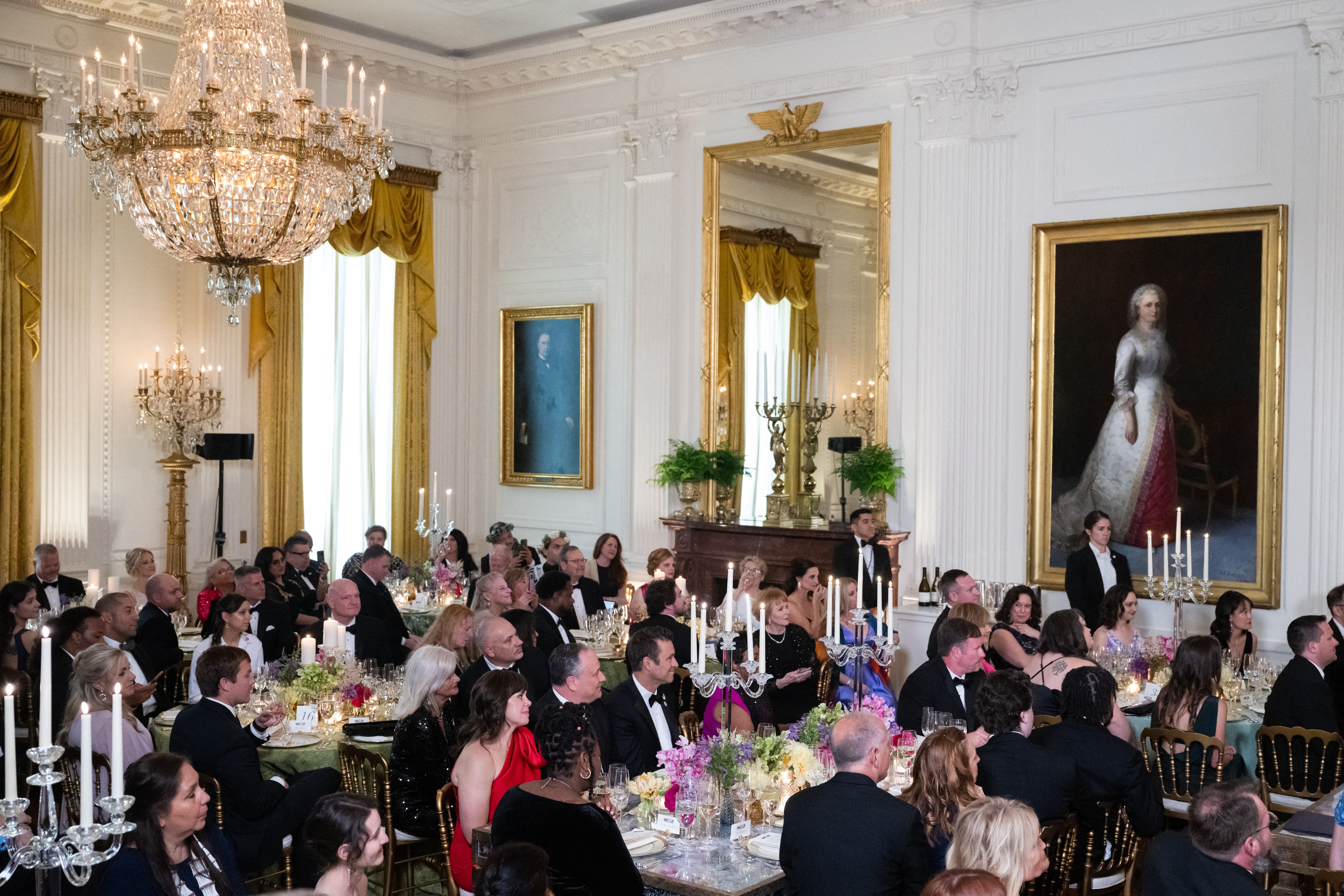  Guests listen to US First Lady Jill Biden (out of frame) speak as she hosts the "Teachers of the Year" State Dinner, an event honoring the 2024 National Teachers of the Year, in the East Room of the White House in Washington, DC on May 2, 2024.