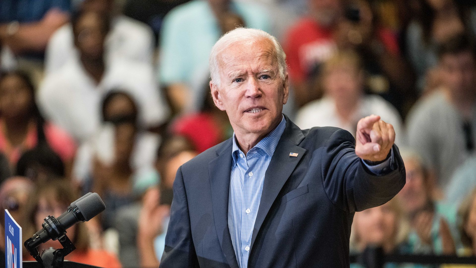 Joe Biden giving a speech, making a dramatic gesture, with the crowd behind him.