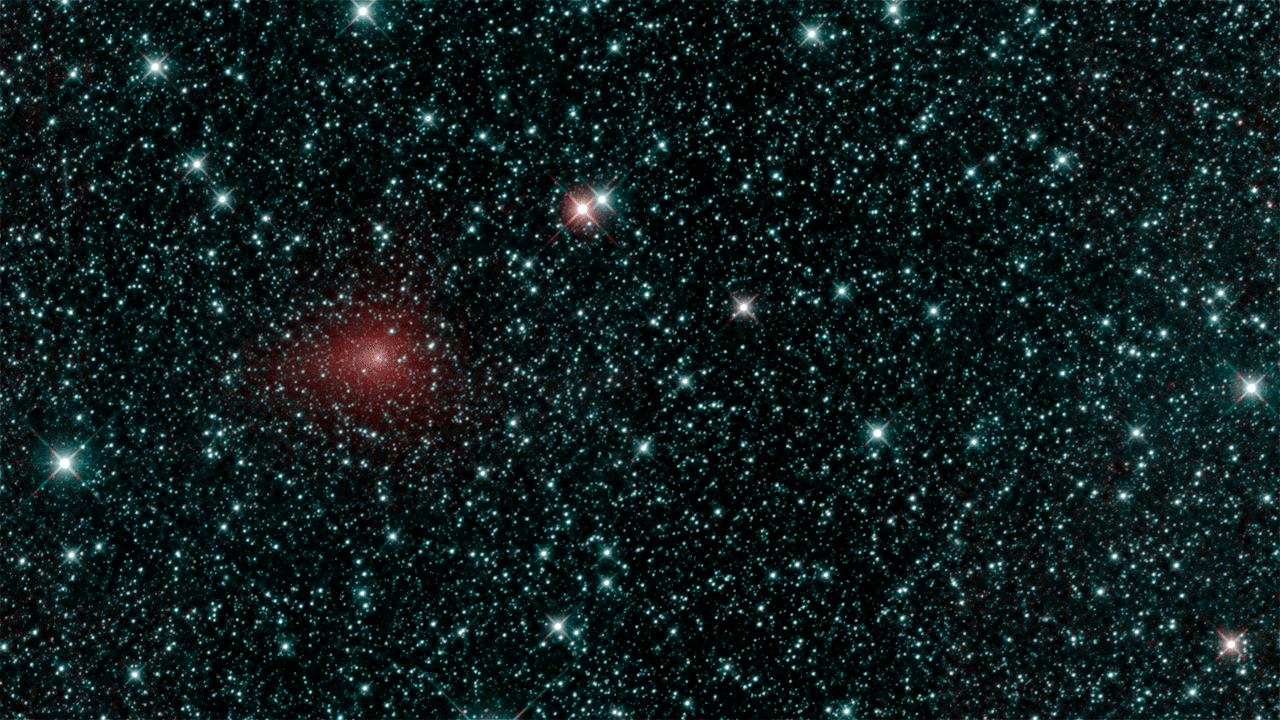 A comet in red moving across the sky.