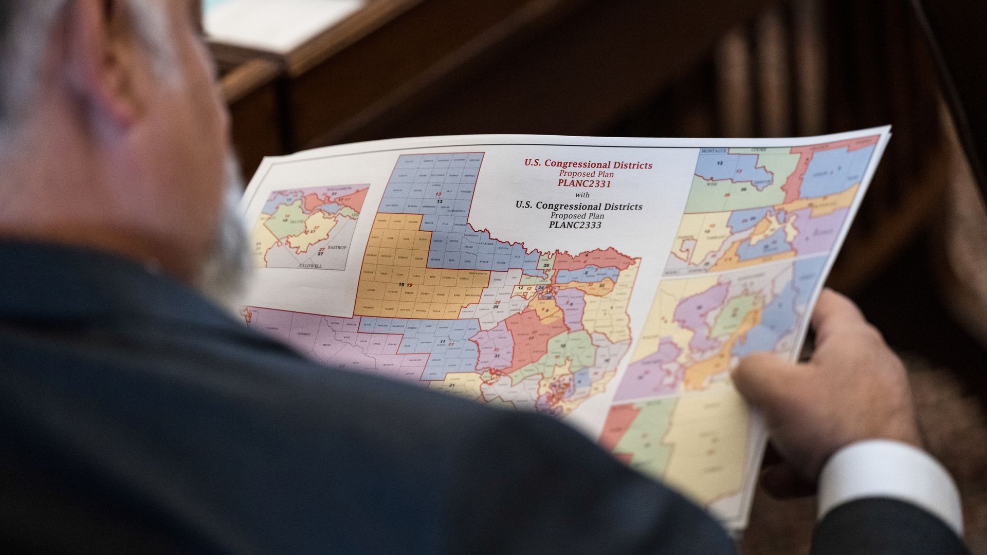 State Representative Matt Morgan, a Republican from Texas, reviews a map of proposed congressional redistricting on a sheet of paper at the Texas State Capitol in Austin in August.