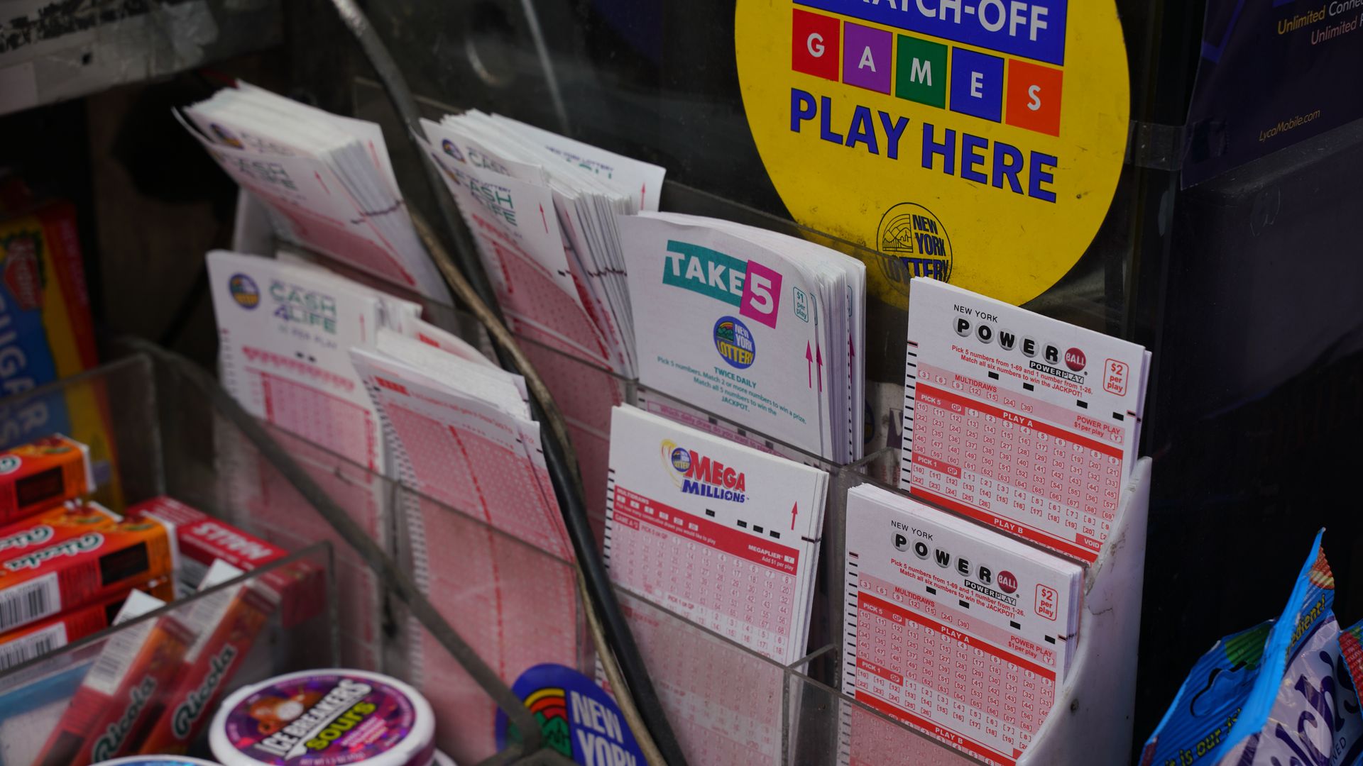 Powerball and lottery ticket slips in a display