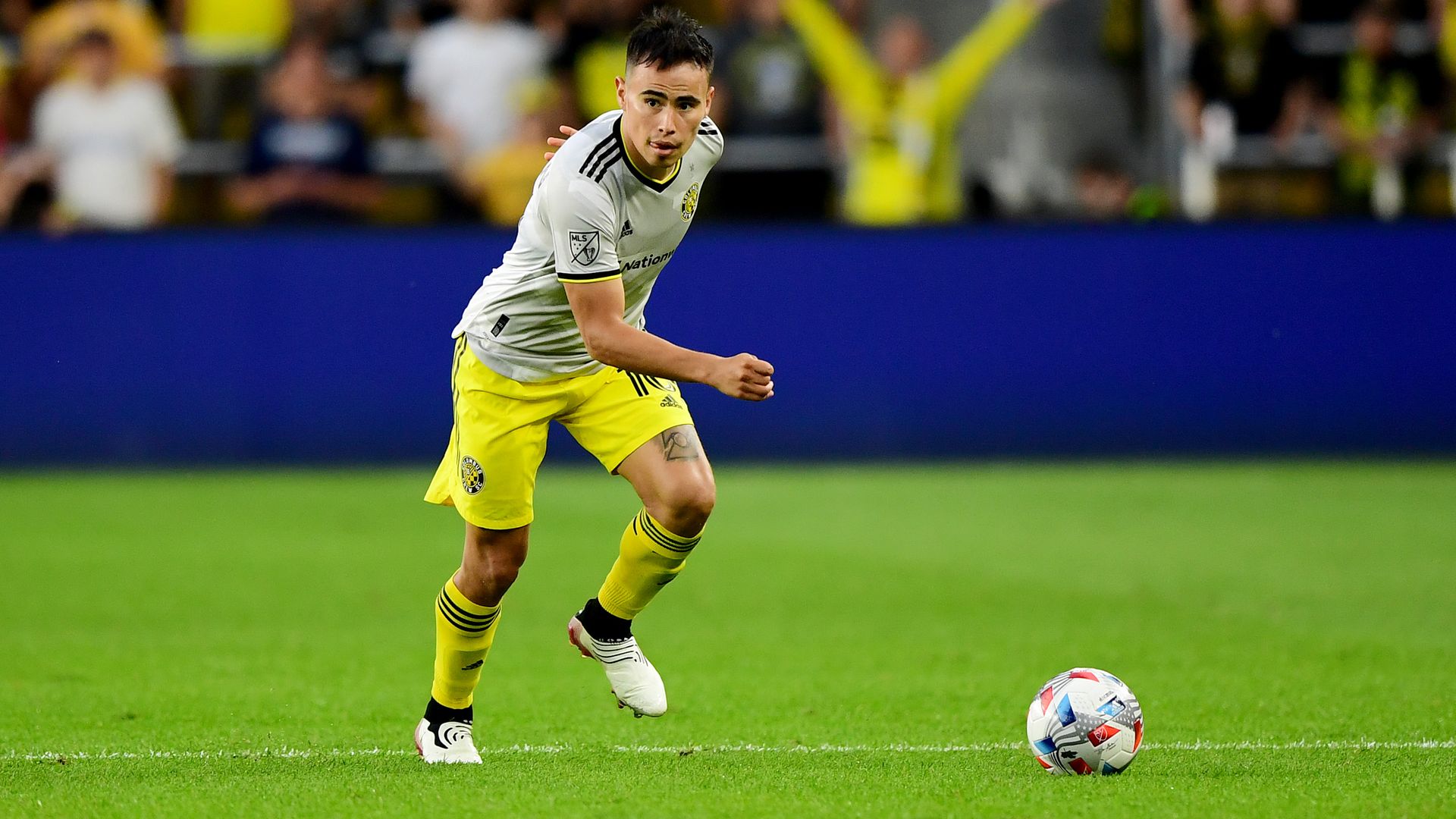Columbus Crew soccer player Lucas Zelarayan runs toward a ball in preparation for a kick.