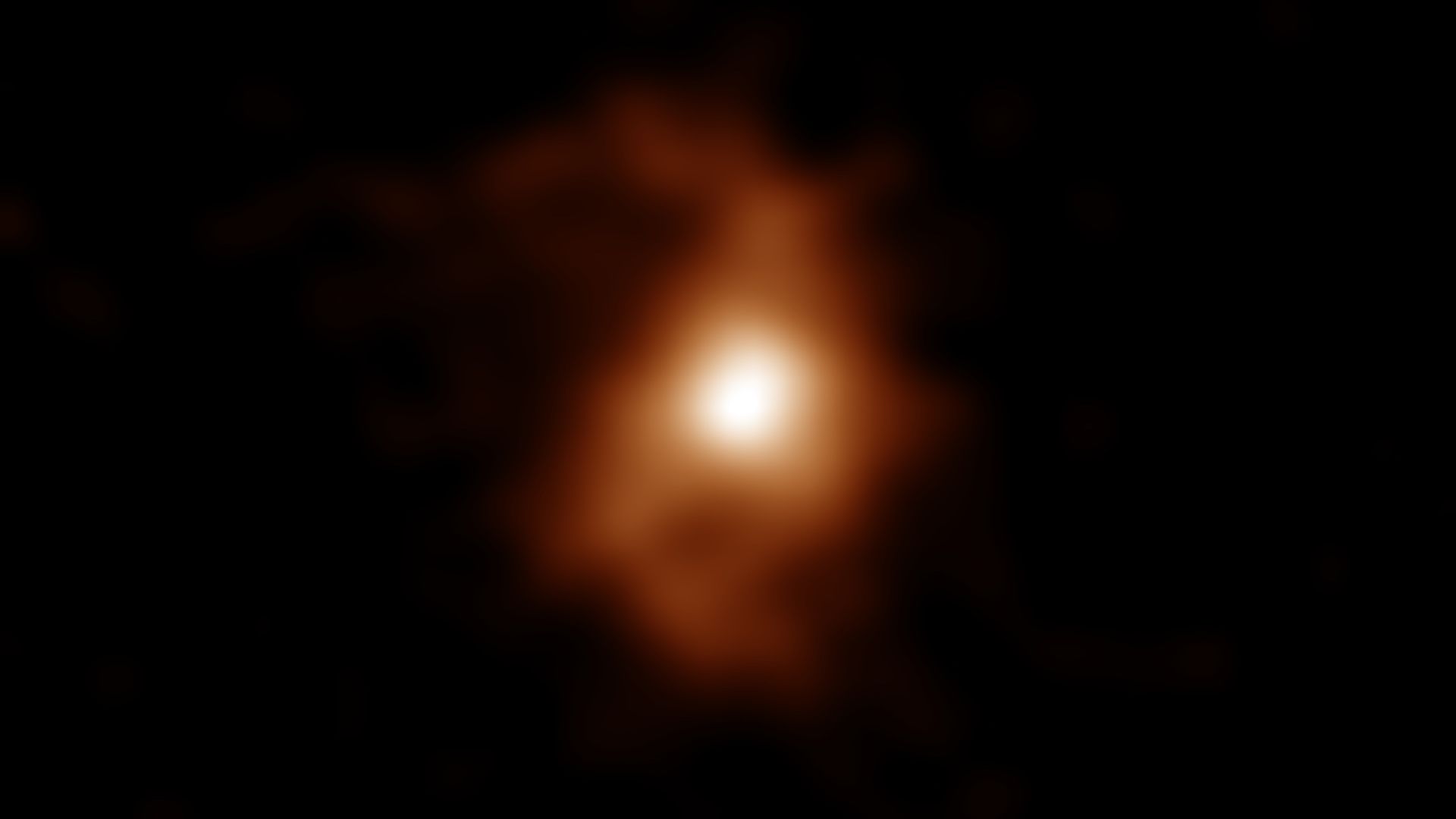 An orange and yellow image of a galaxy in the early universe