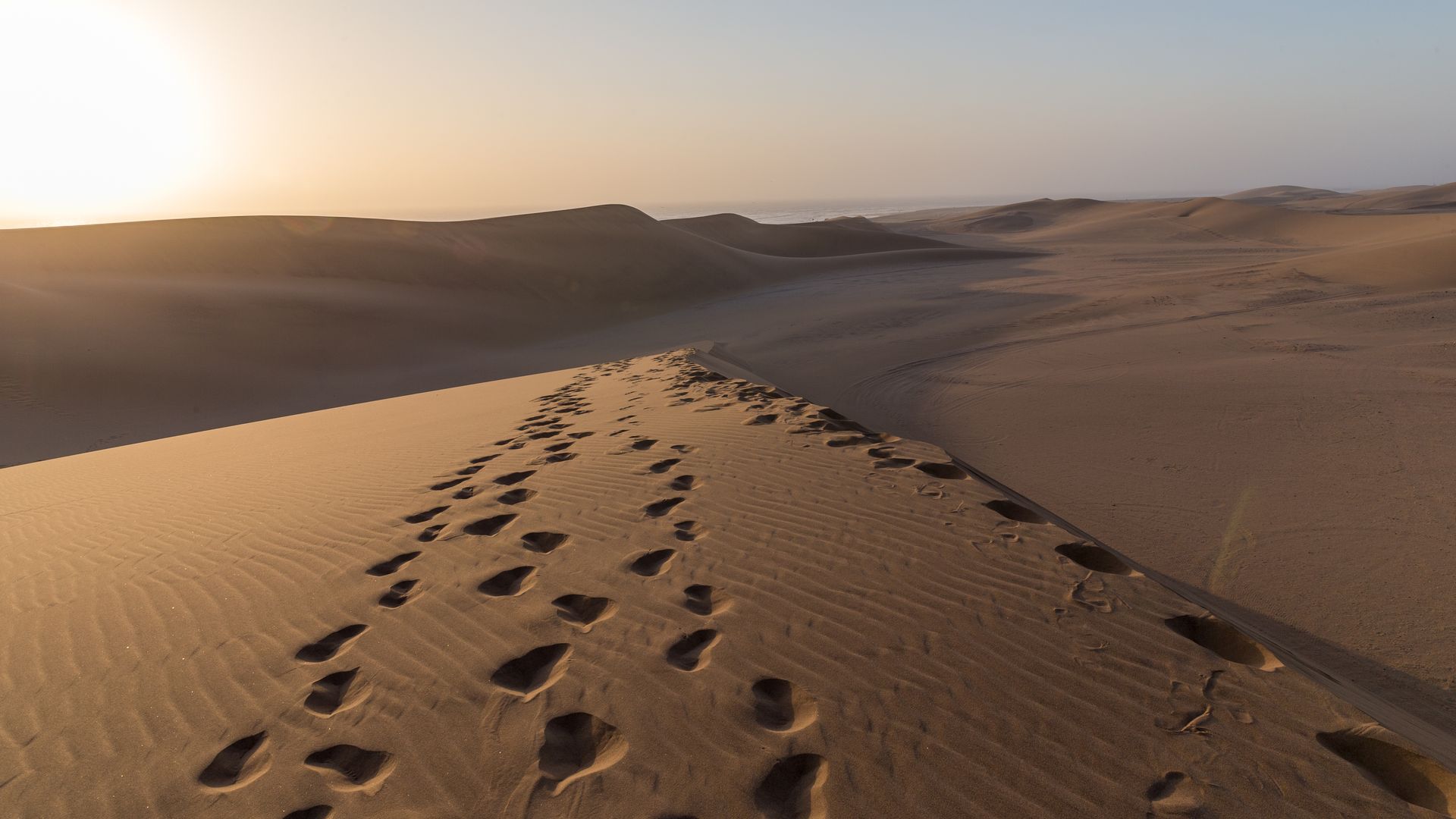 Footprints can be seen on the sand of a desert during sunset near Swakopmund, Namibia, on April 2, 2019.