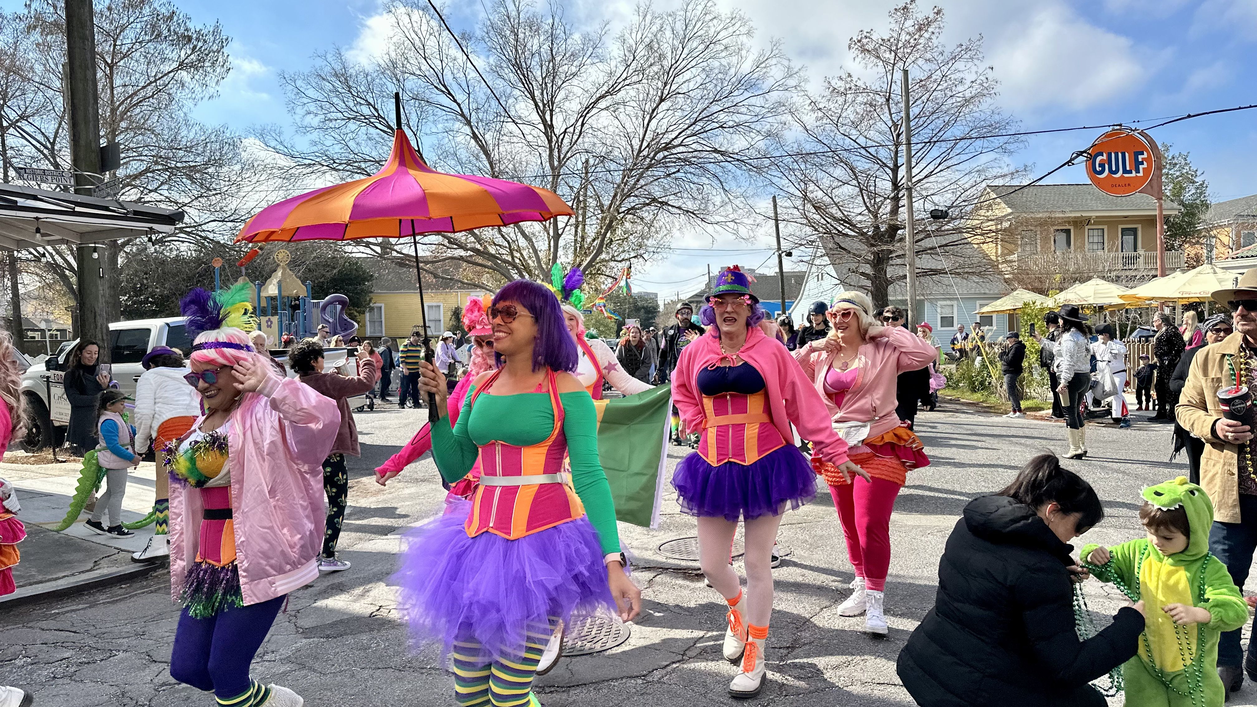 Photo shows children in costume walking in the Krewe of Confetti Kids parade in Algiers Point in New Orleans.