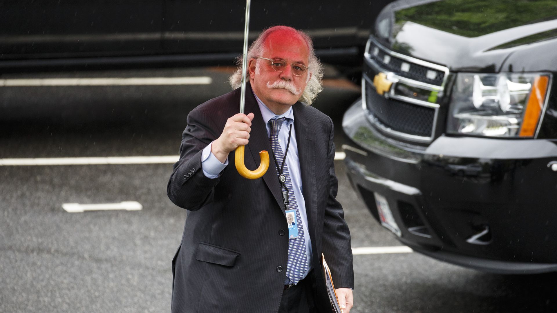 Ty Cobb, White House special counsel, holds an umbrella, near the White House.