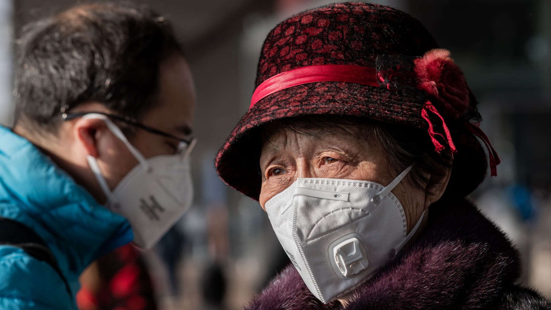People wearing masks while traveling through the Beijing Capital International Airport