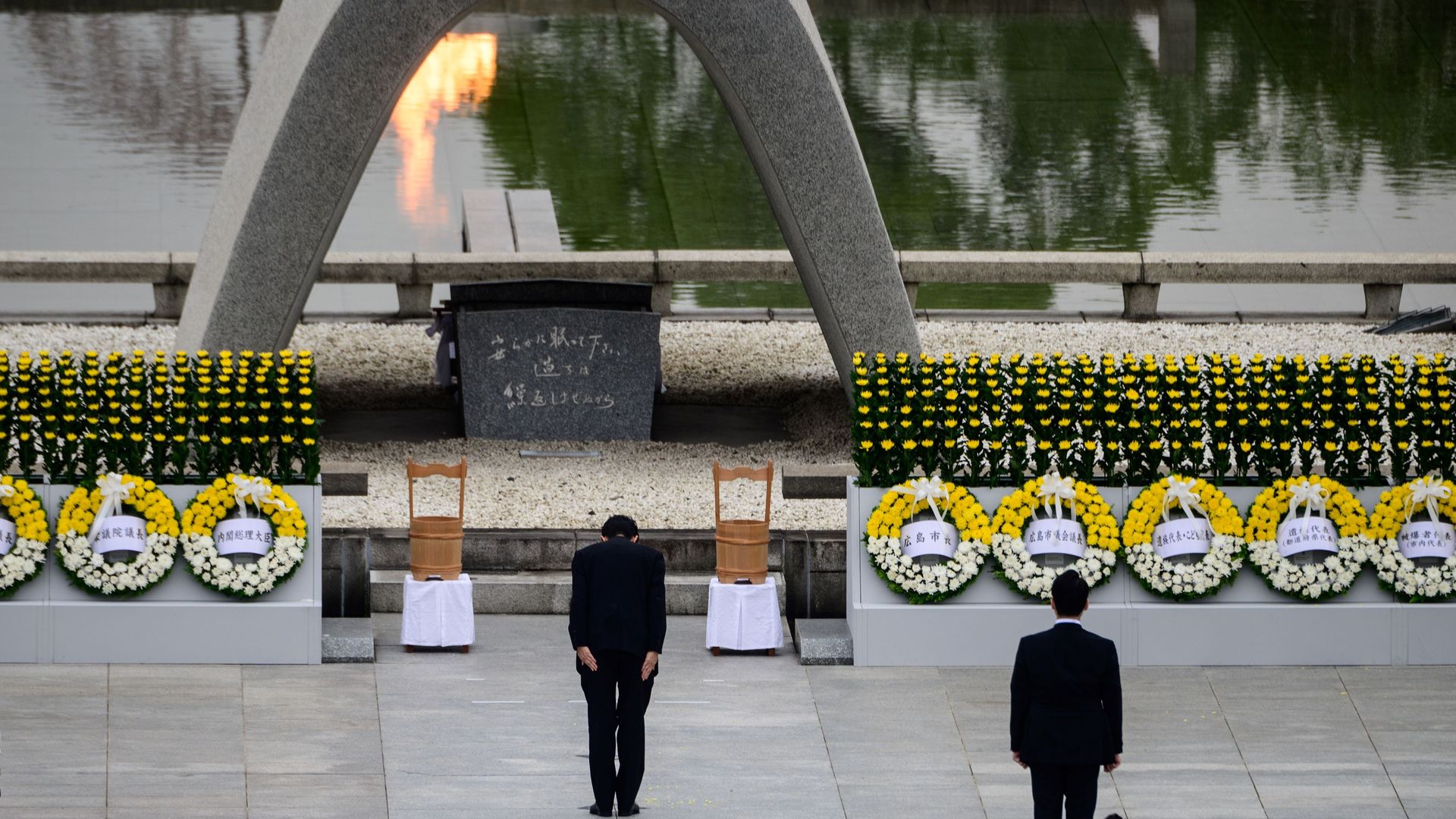 Japanese Prime Minister Shinzo Abe bows in front of the Memorial Cenotaph on the 75th anniversary memorial service for atomic bomb victims at the Peace Memorial Park in Hiroshima on August 6