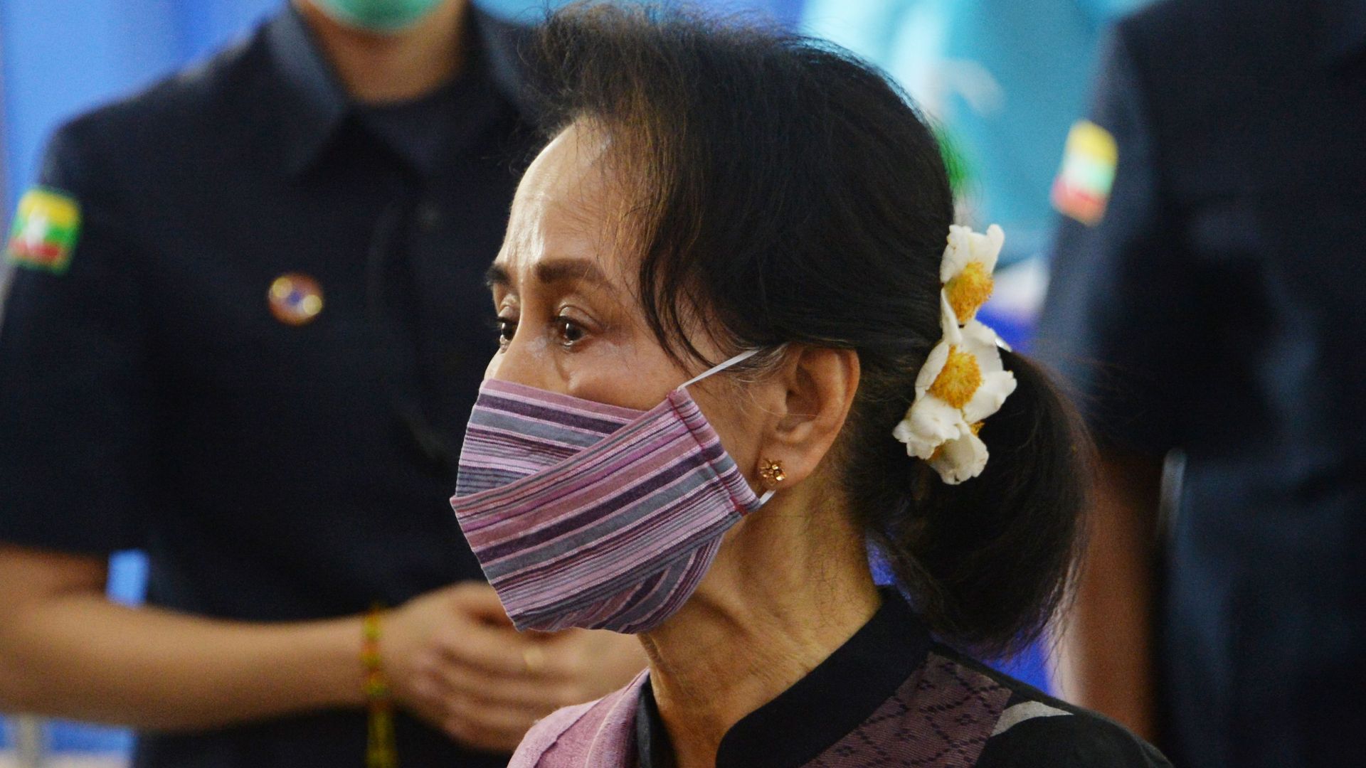Myanmar's State Counsellor Aung San Suu Kyi looks on as health workers receive a vaccine for the Covid-19 coronavirus at a hostipal in Naypyidaw on january 27
