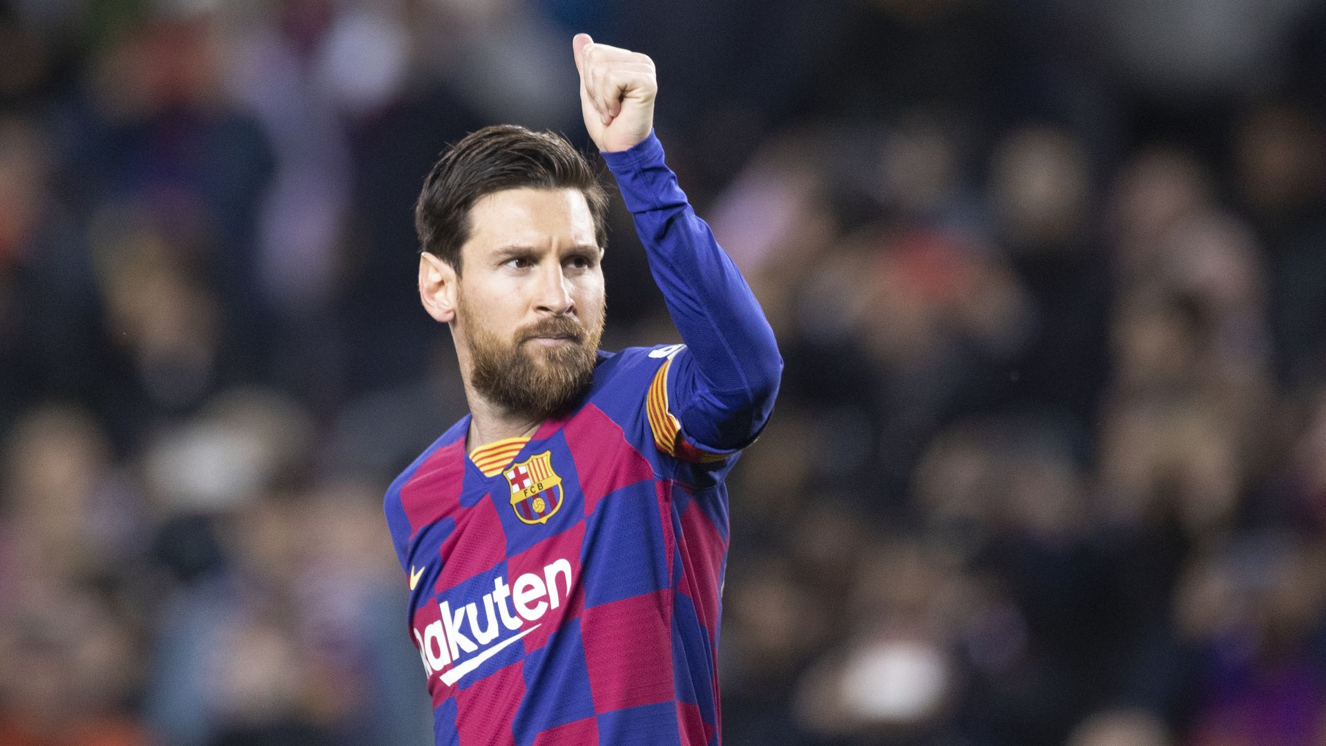 Barcelona player Lionel Messi raising his first during a game