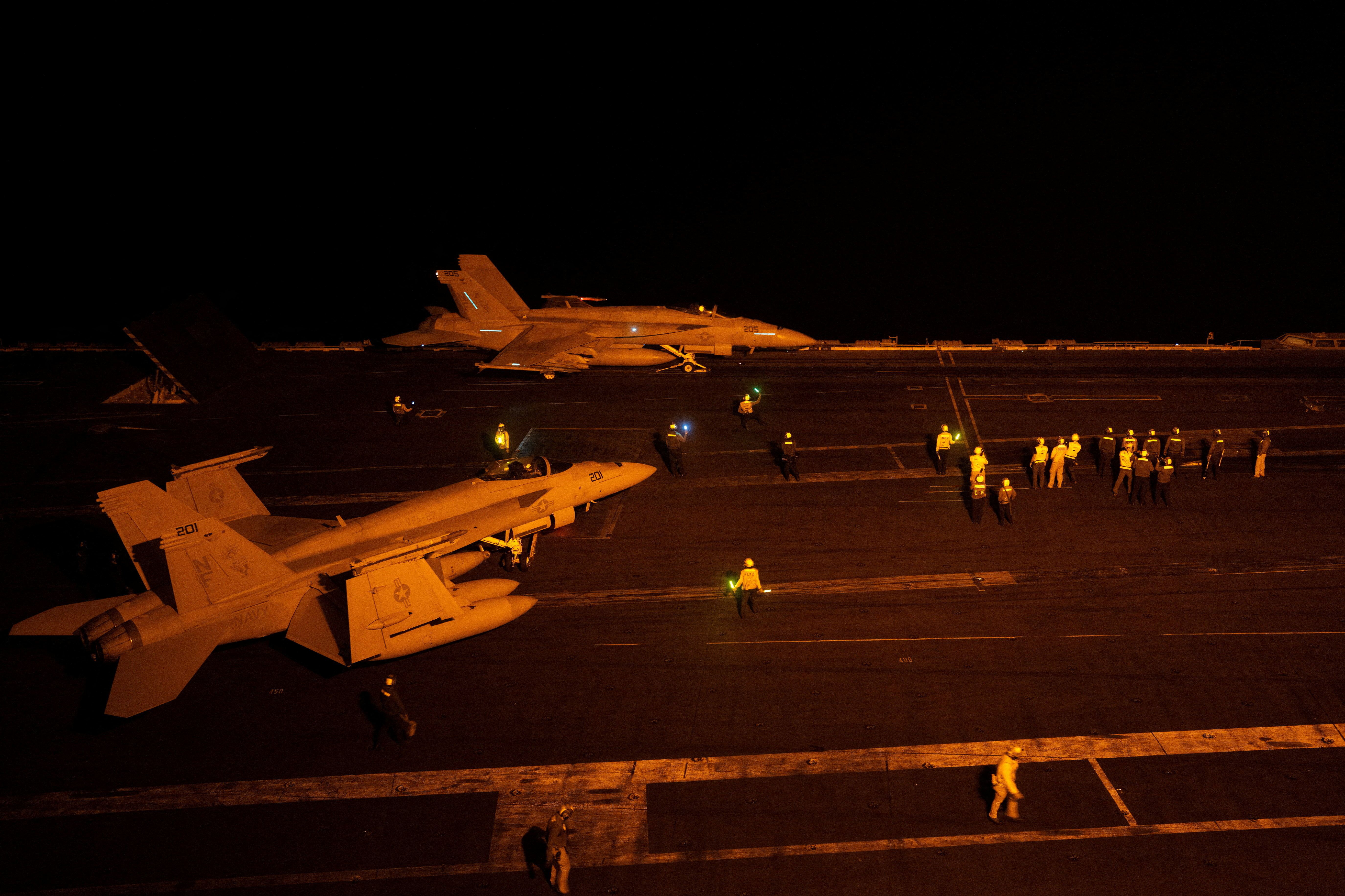 A fighter jet takes off during nighttime operations from the flight deck of the USS George Washington in the Arabian Sea on Saturday.