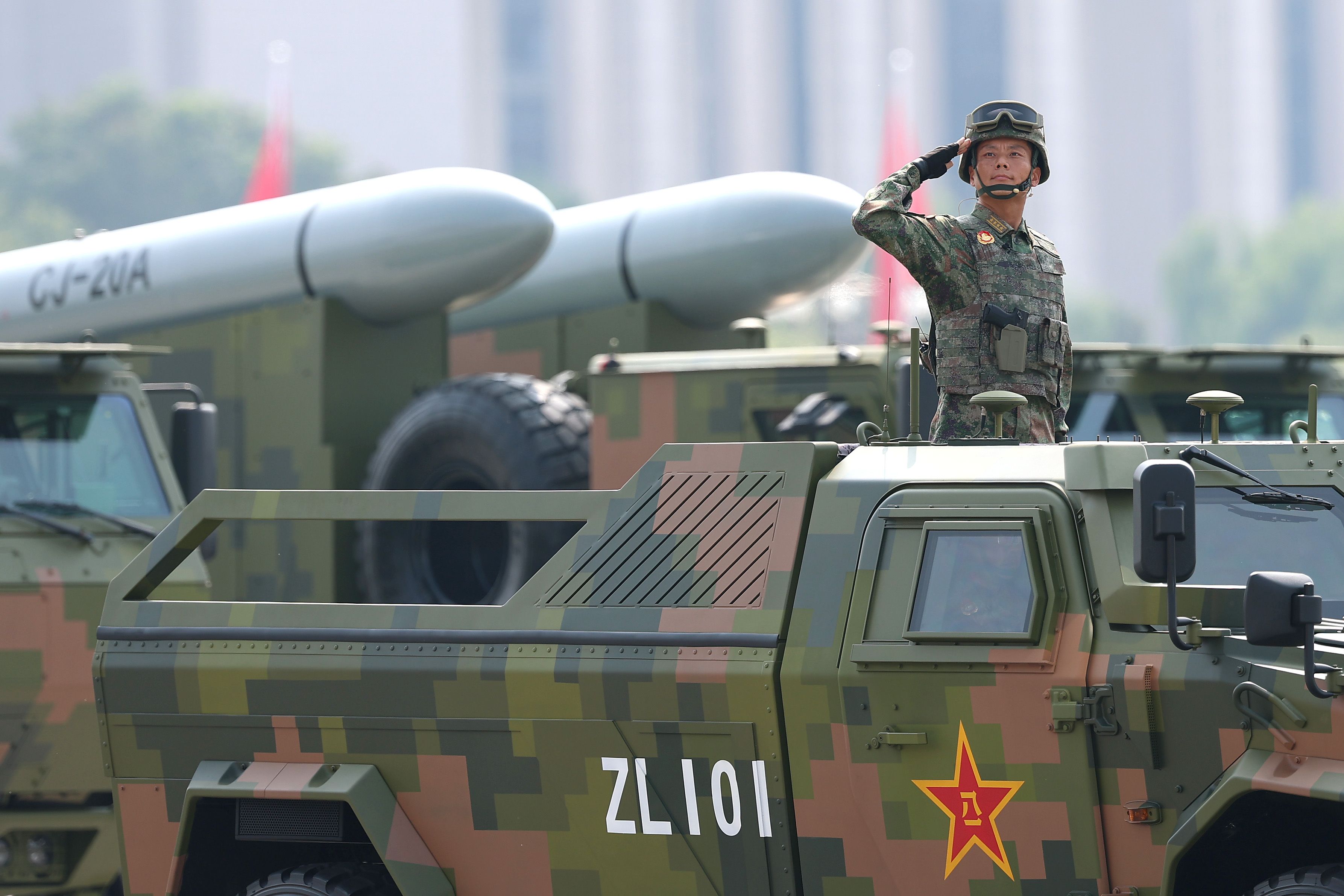 Armoured vehicles and soldiers are seen during a military parade marking the 80th anniversary of victory over Japan and the end of World War II.