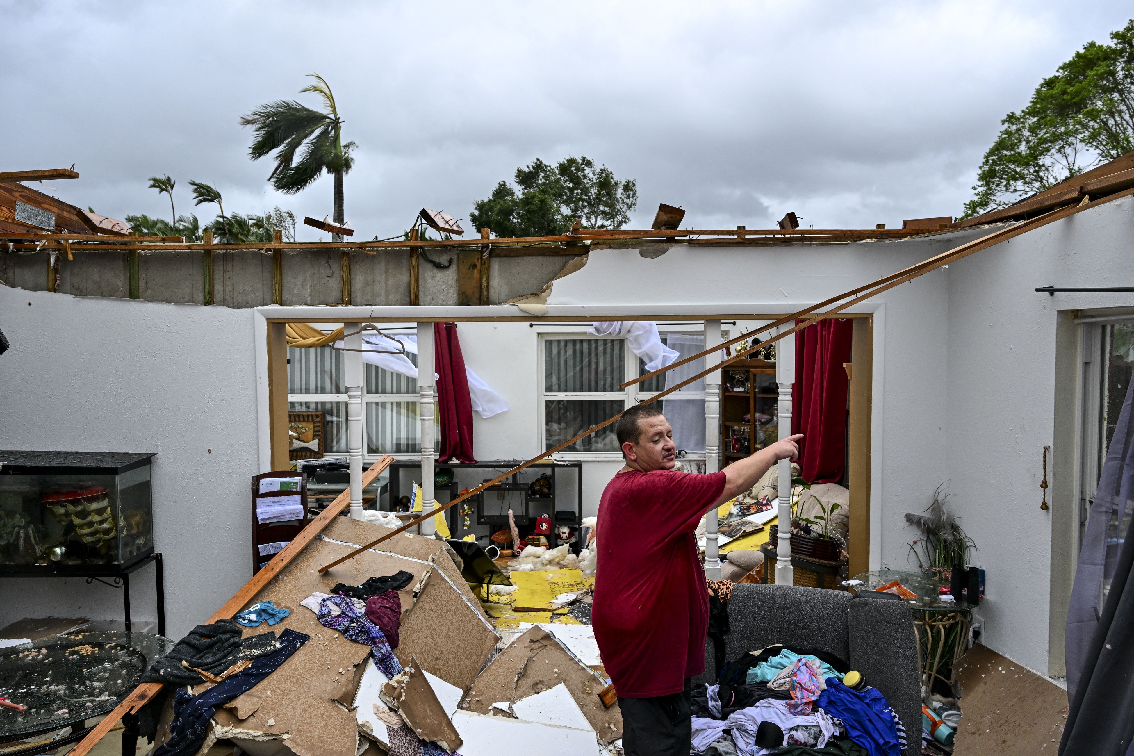 Robert Haight looks around his destroyed house after it was hit by a reported tornado in Fort Myers, Florida, on October 9, 2024, as Hurricane Milton approaches. Florida residents fled or just hunkered down in the final hours October 9 before Milton pummels the state, as government emergency relief 