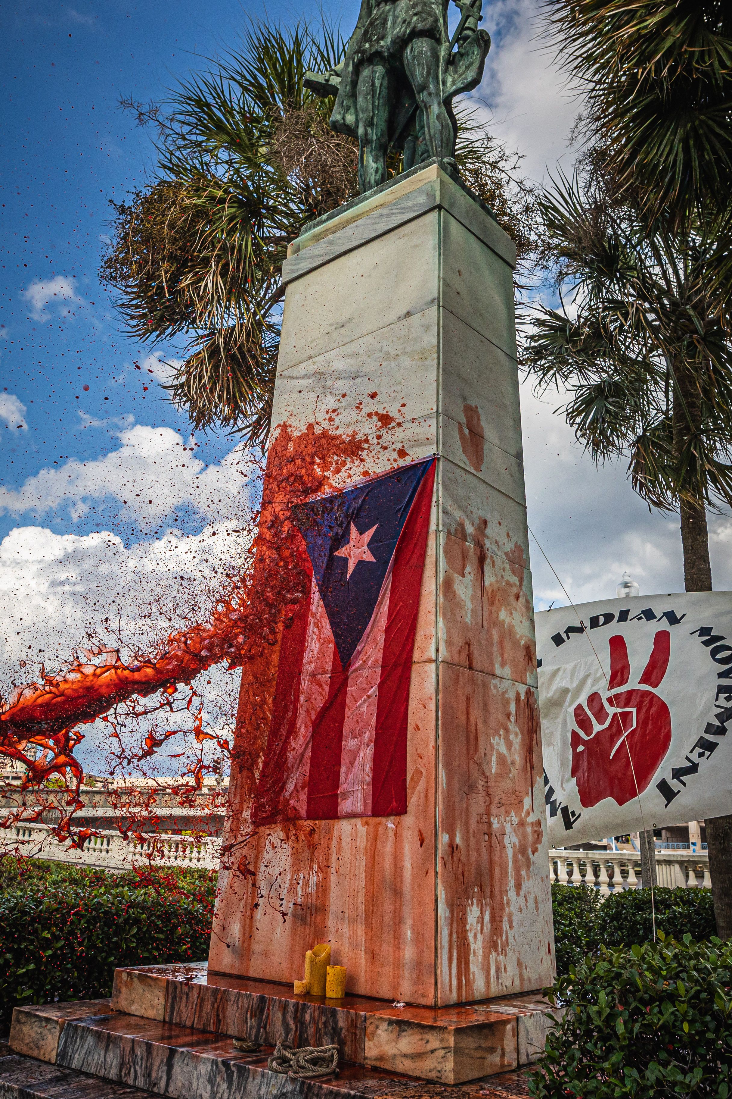fake blood splashing onto Tampa's Christopher Columbus monument