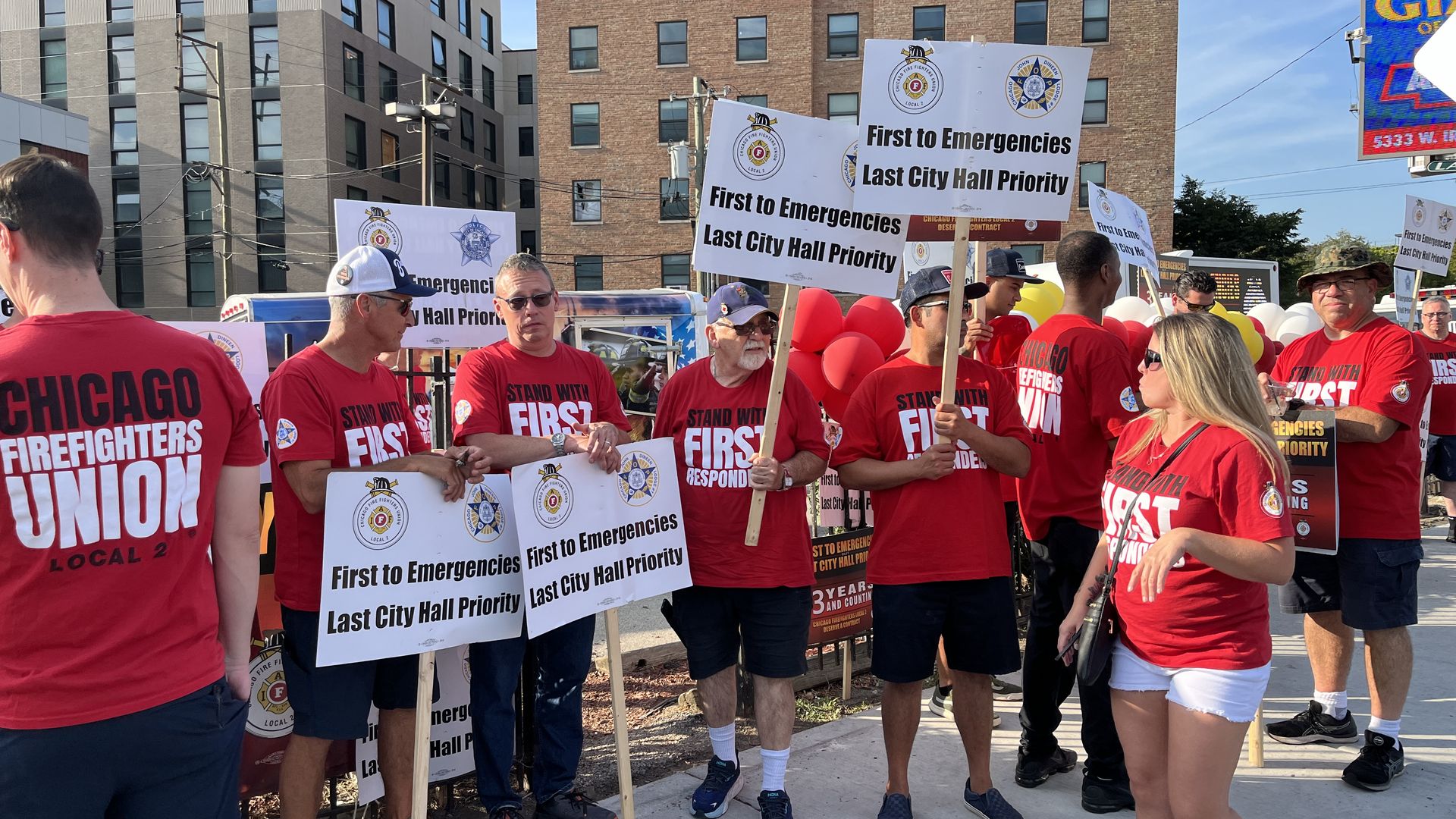 workers picket in red shirts