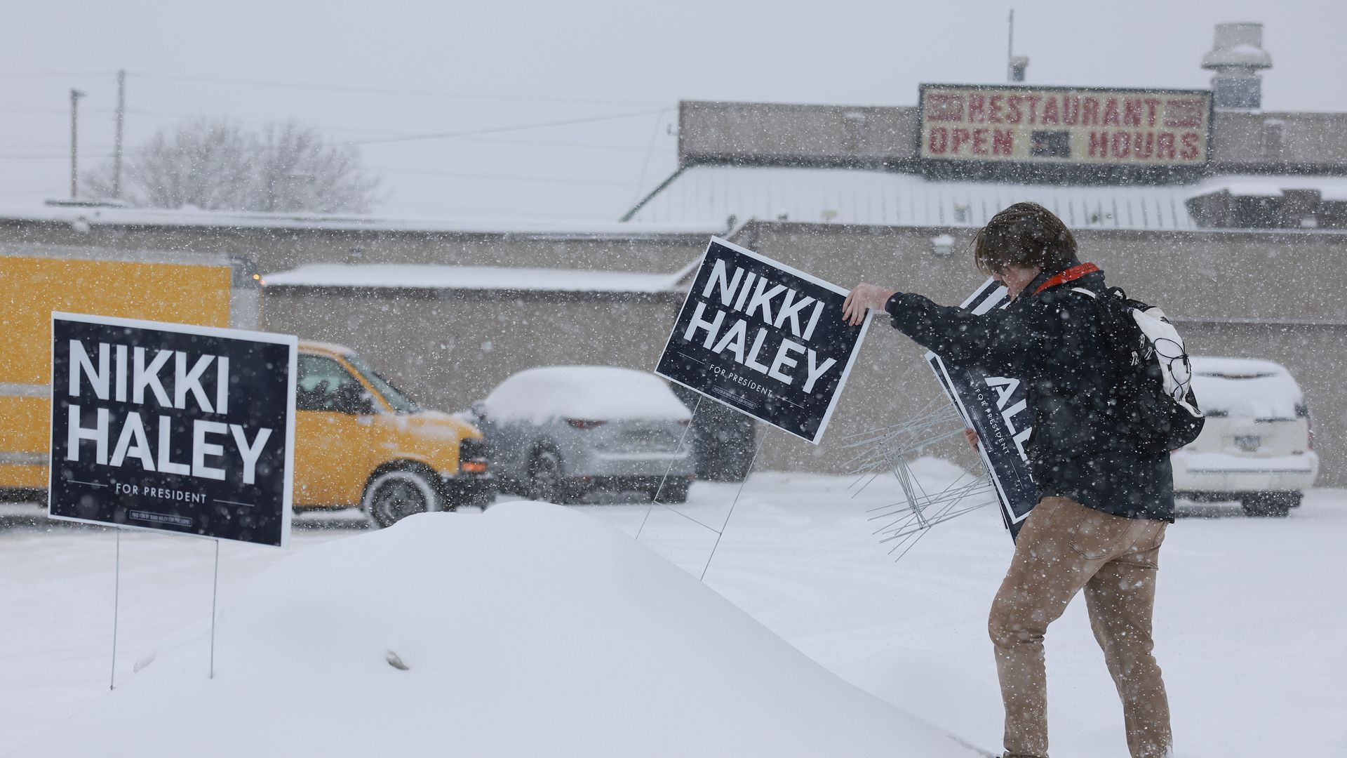 a volunteer grabbing nikki haley signs