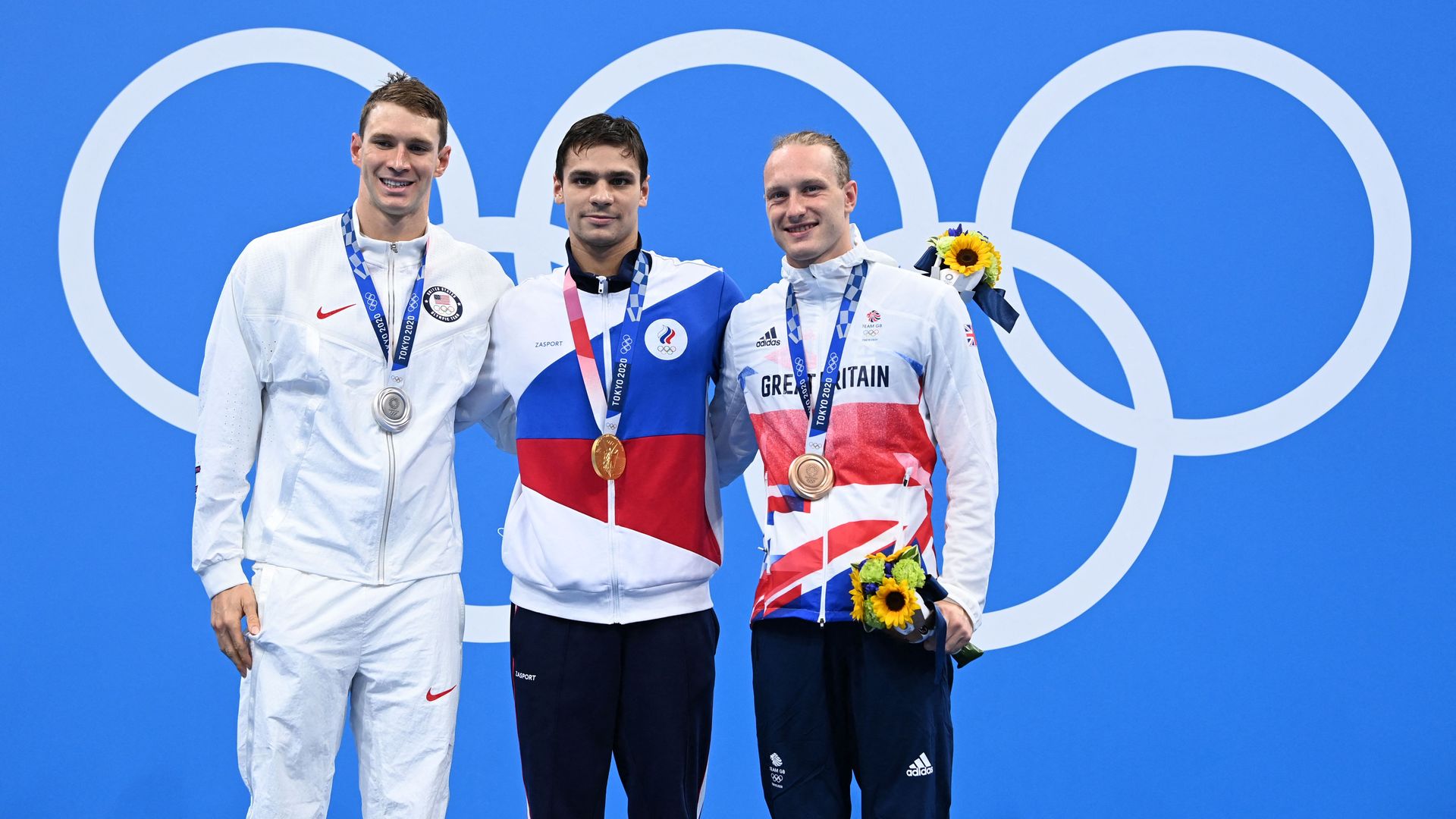 Athletes pose with their medals after the 200m backstroke final.