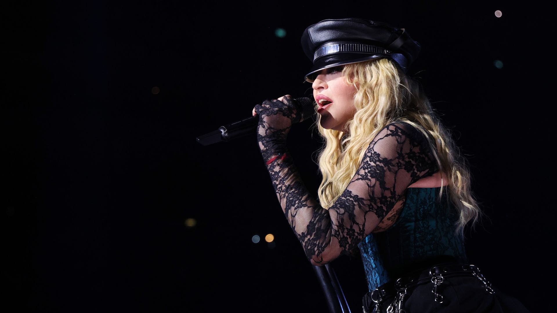 Madonna signs into a microphone 