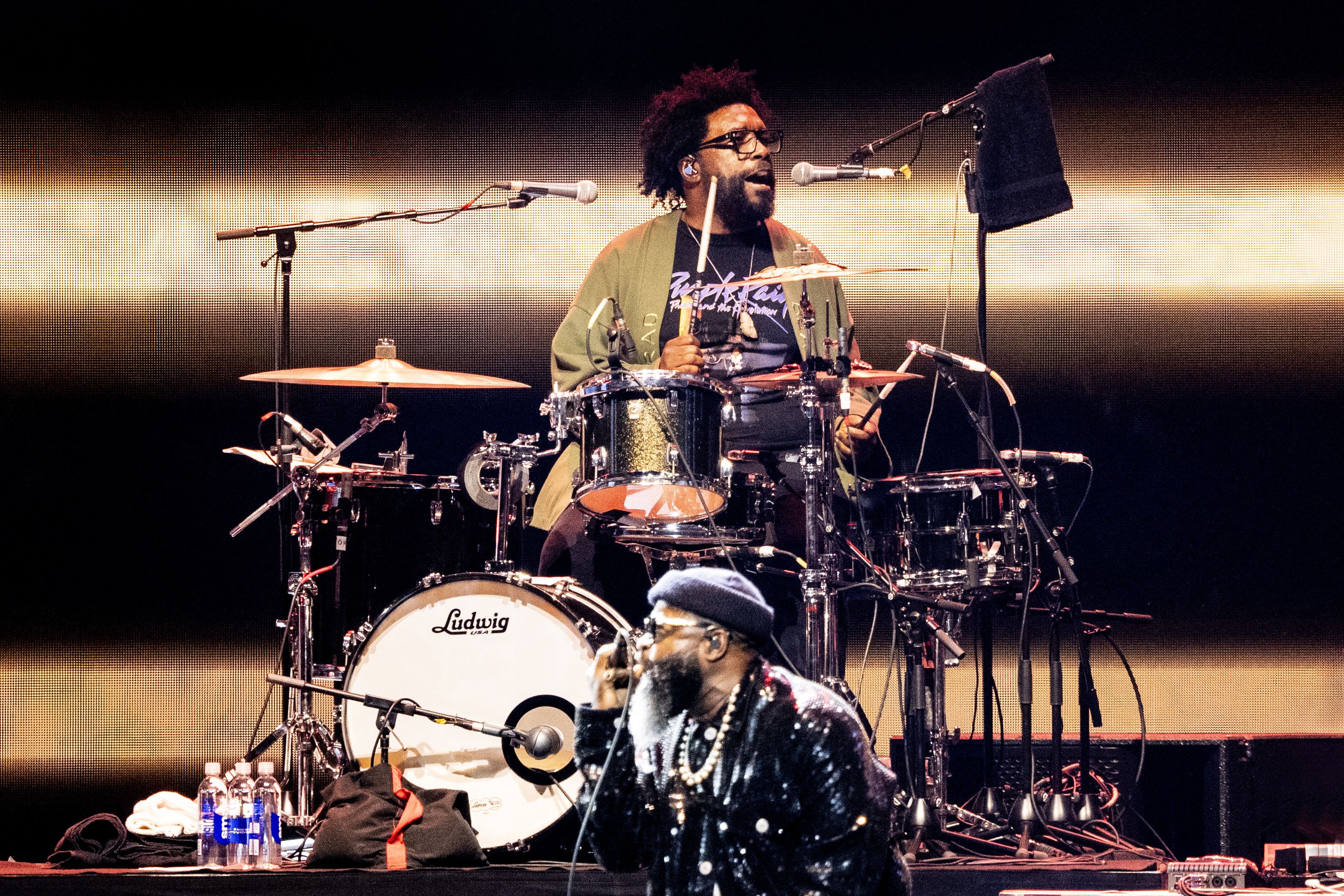 Photo shows Questlove and Black Thought of the Roots performing.