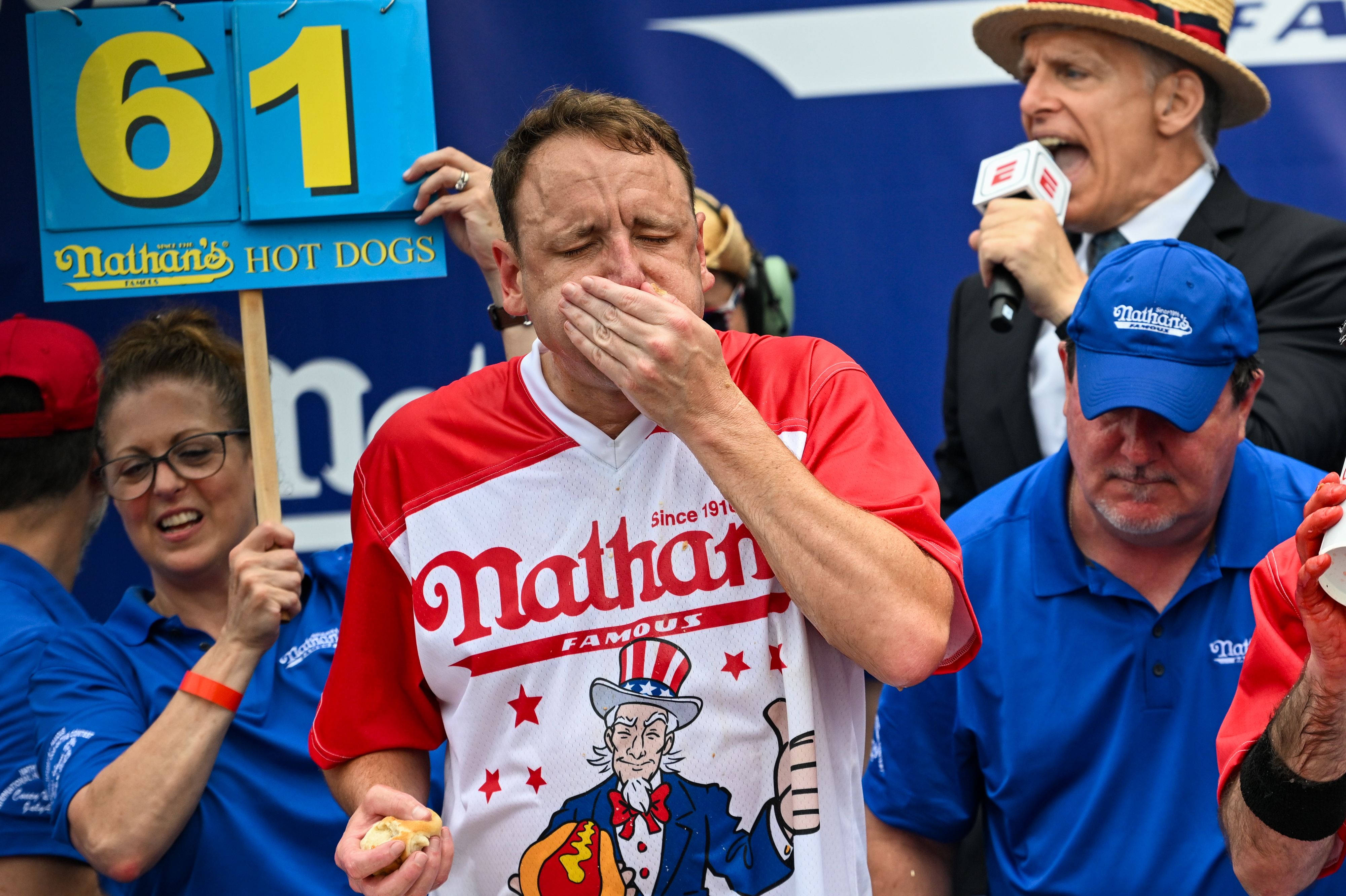 Defending champion Joey Chestnut competes in the 2023 Nathan's Famous Fourth of July International Hot Dog Eating Contest on July 4, 2023 at Coney Island in the Brooklyn borough of New York City. The men's contest was postponed due to thunderstorms but later happened without spectators allowed into the "arena." The annual contest, which began in 1972, draws thousands of spectators to Nathan’s Famous located on Surf Avenue. 
