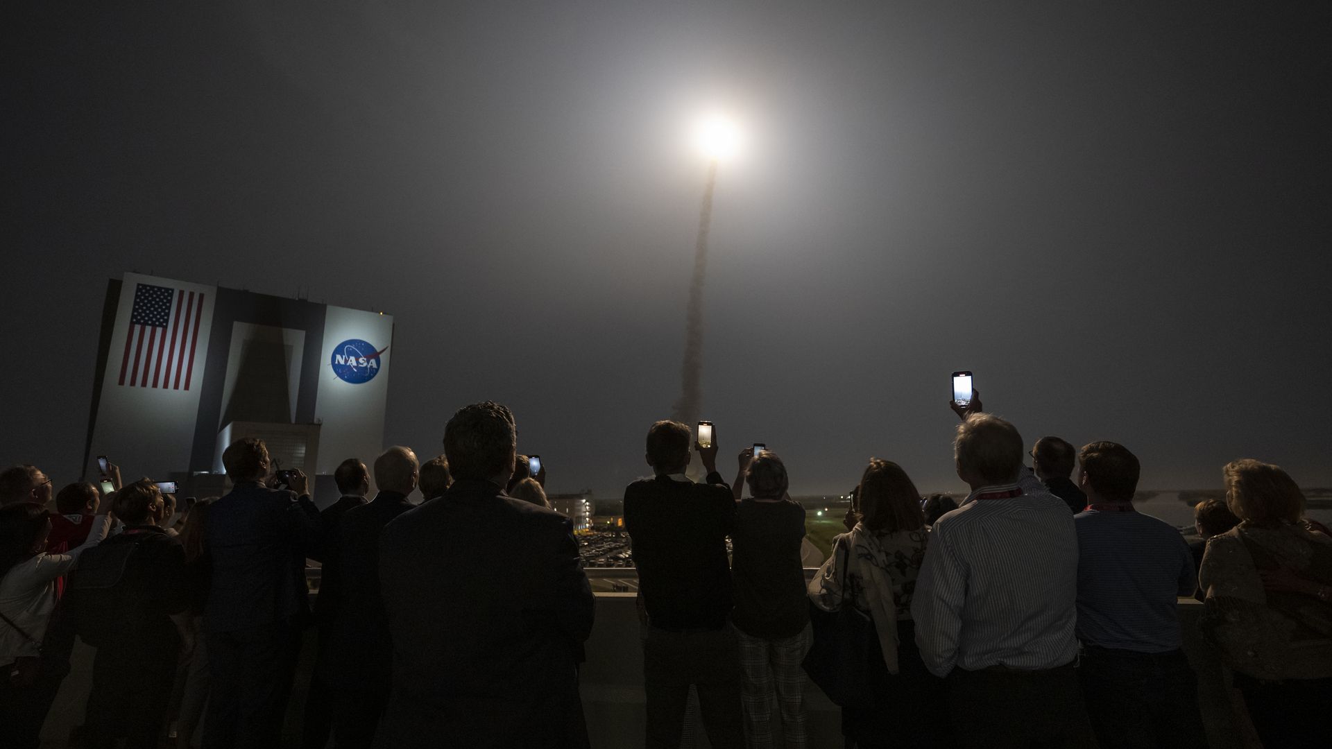 guests watch the launch of NASAs Space Launch System rocket.