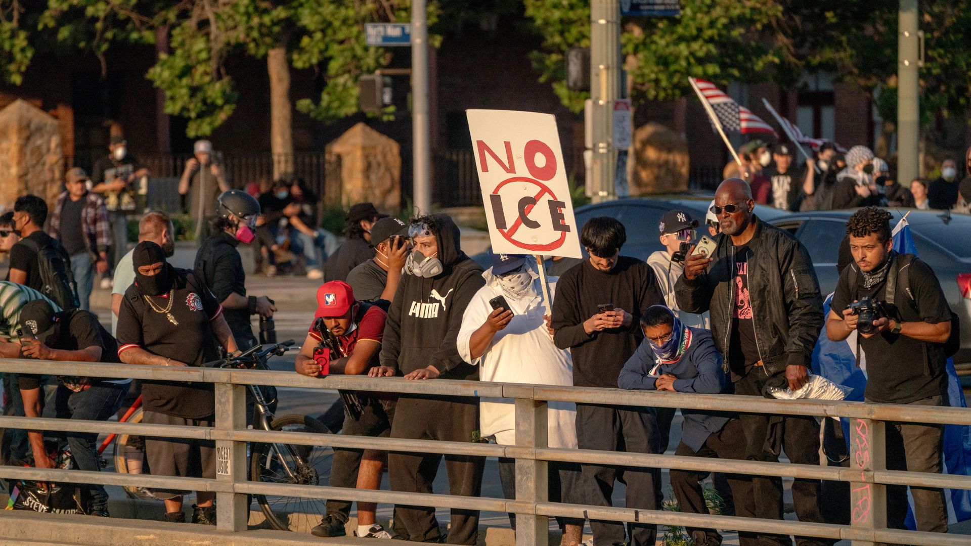 Protesters holding signs protesting ICE enforcement gather along Highway 101 during a demonstration in Los Angeles on June 8, 2025.