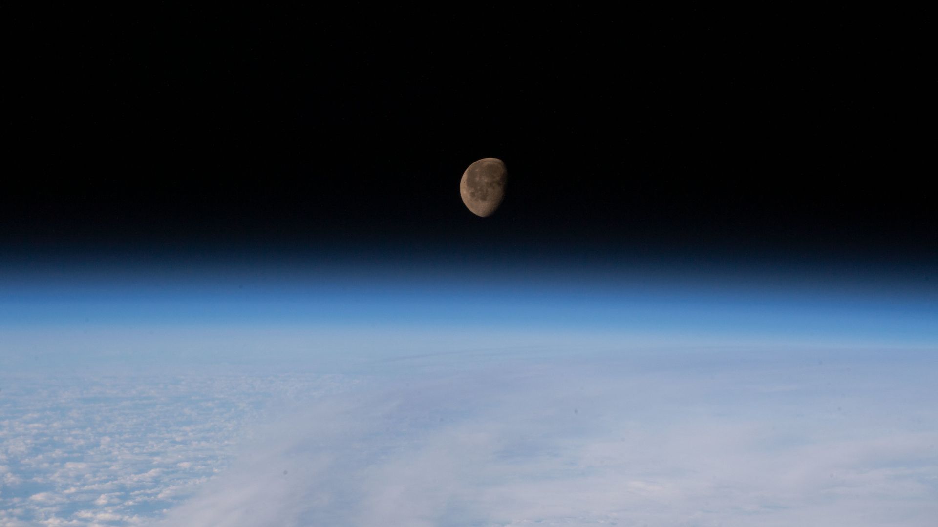 The Moon hanging above the limb of the Earth as seen from the International Space Station