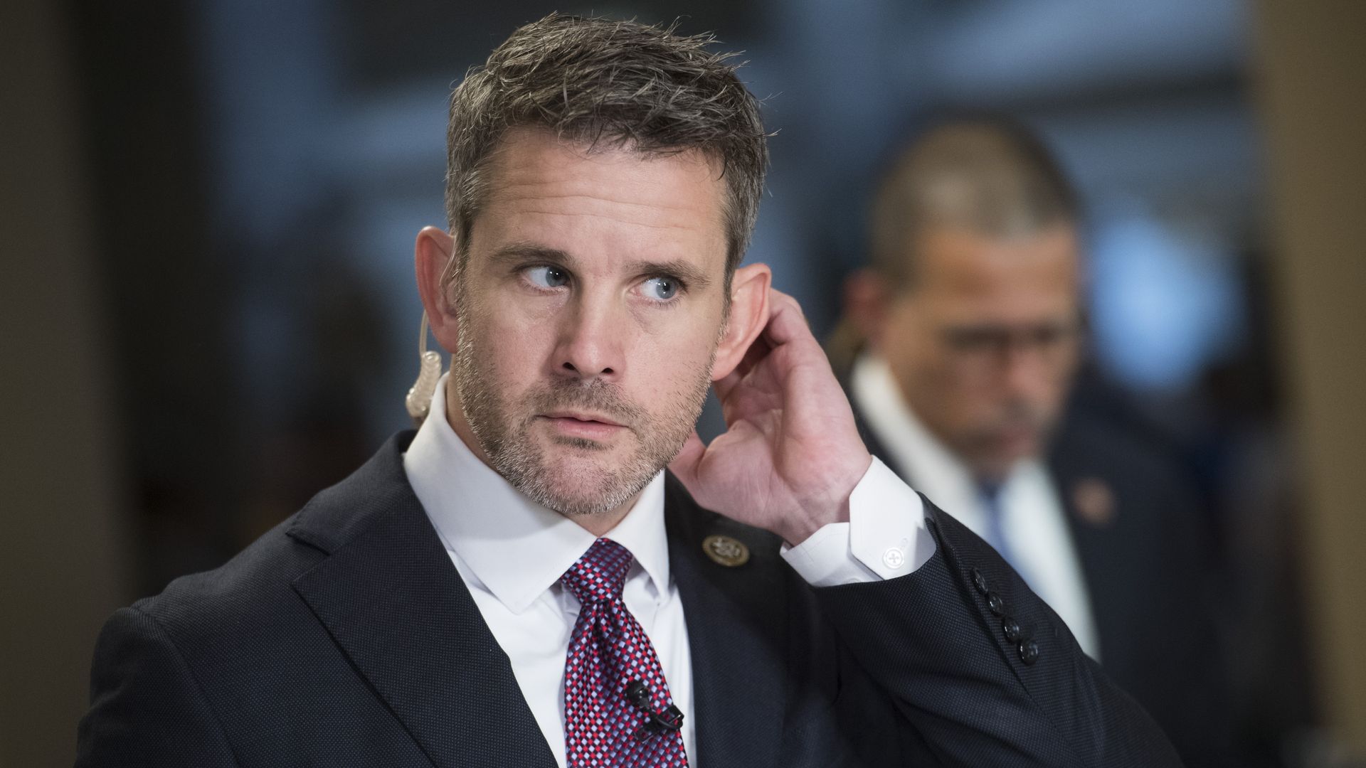 Reps. Adam Kinzinger, R-Ill. prepares for television interviews in the Capitol on Friday, June 21