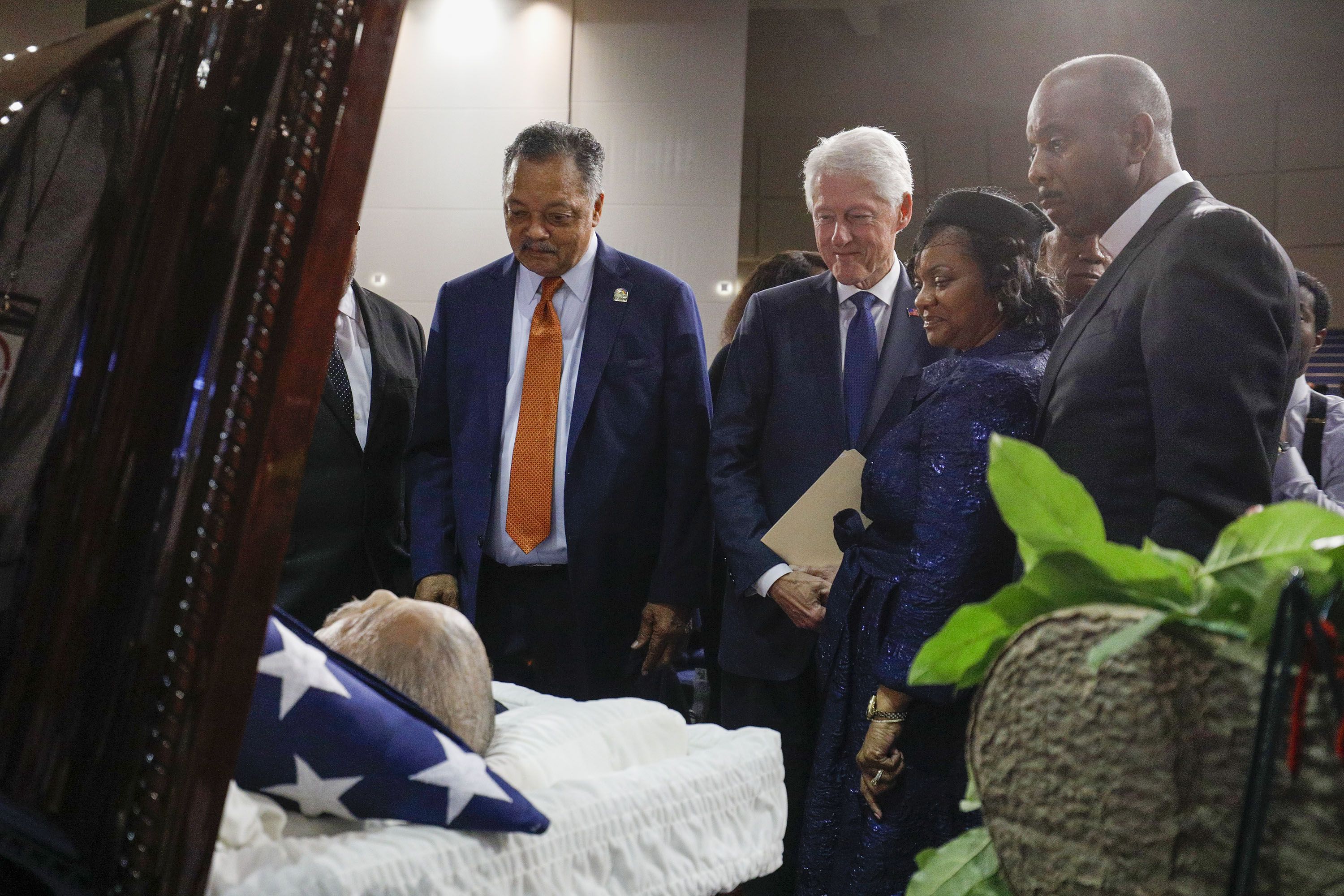 The Rev. Jesse Jackson, former President Bill Clinton, and Monica Conyers at the casket of John Conyers Jr. in 2019 in Detroit.