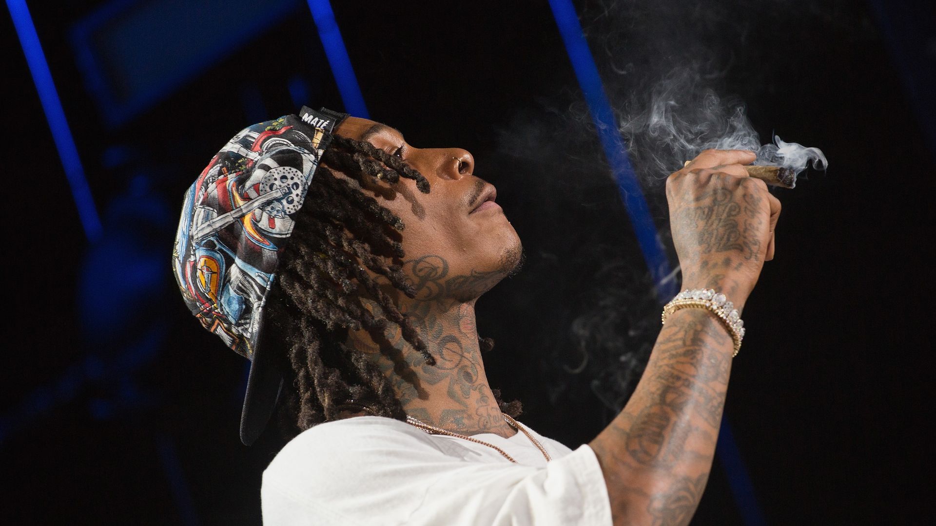 Rapper Wiz Khalifa performs onstage during the 'Dazed & Blazed Summer 2018 Tour' at Austin360 Amphitheater while smoking a blunt on stage