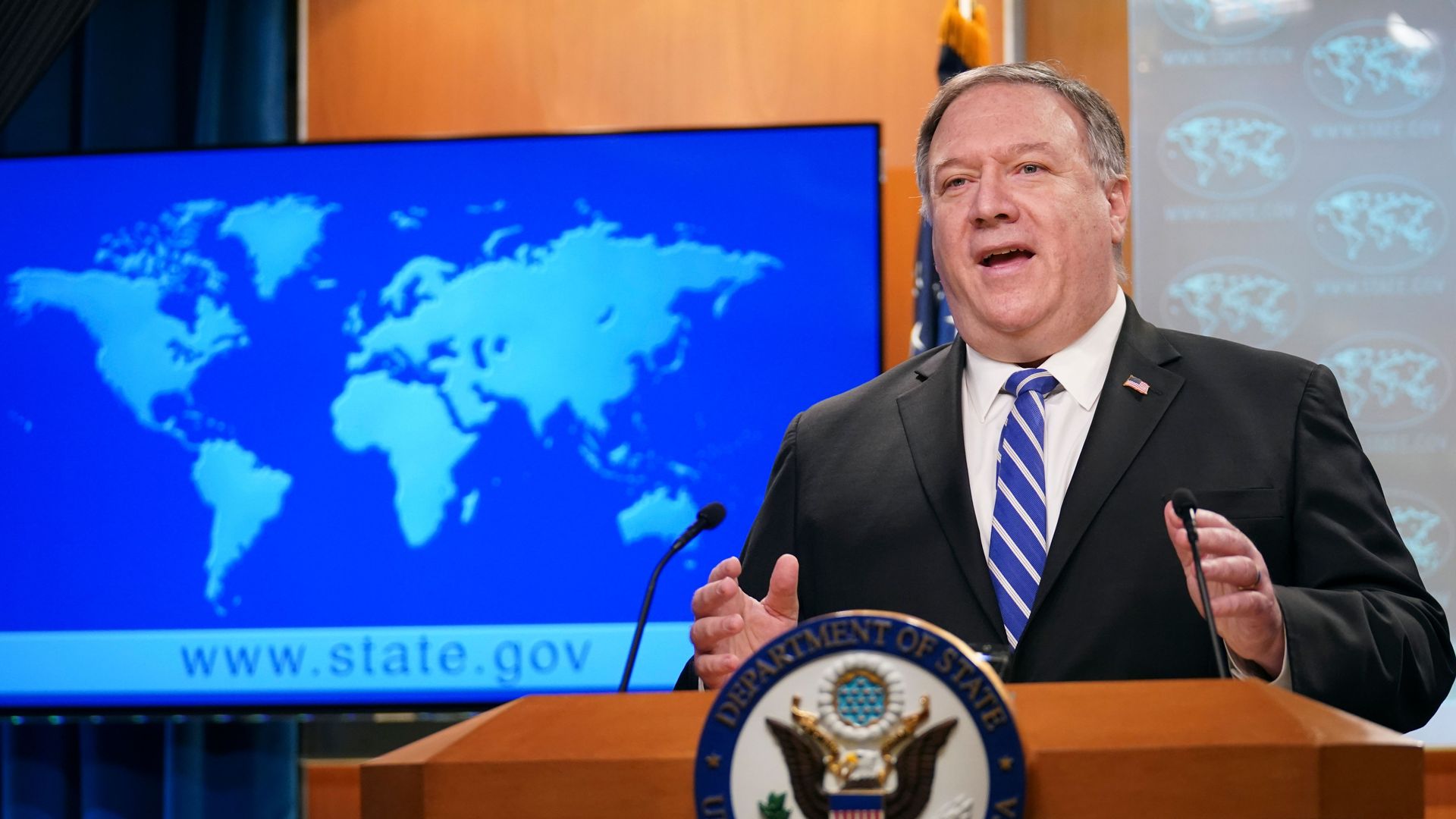 Secretary of State Mike Pompeo speaks at a podium while waving his hands.