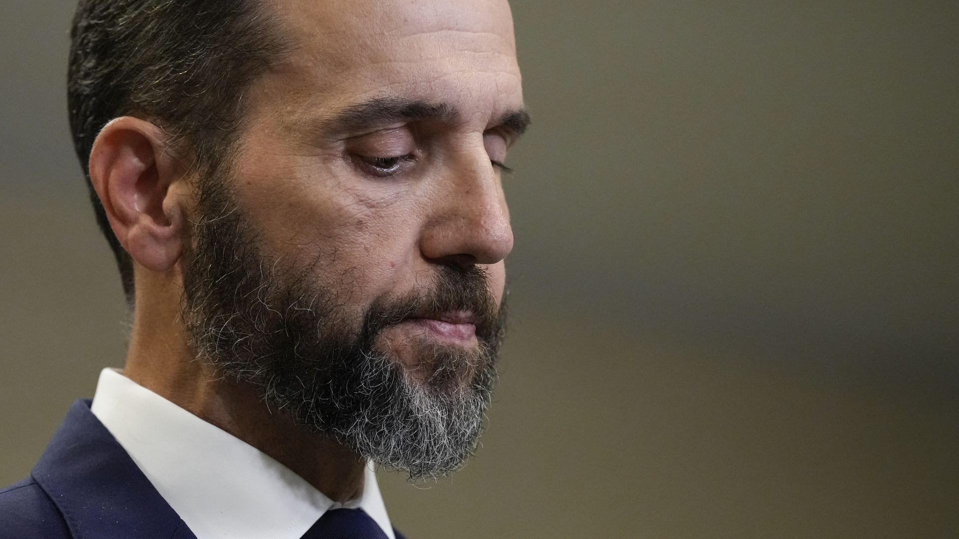 Jack Smith looks down before delivering remarks.