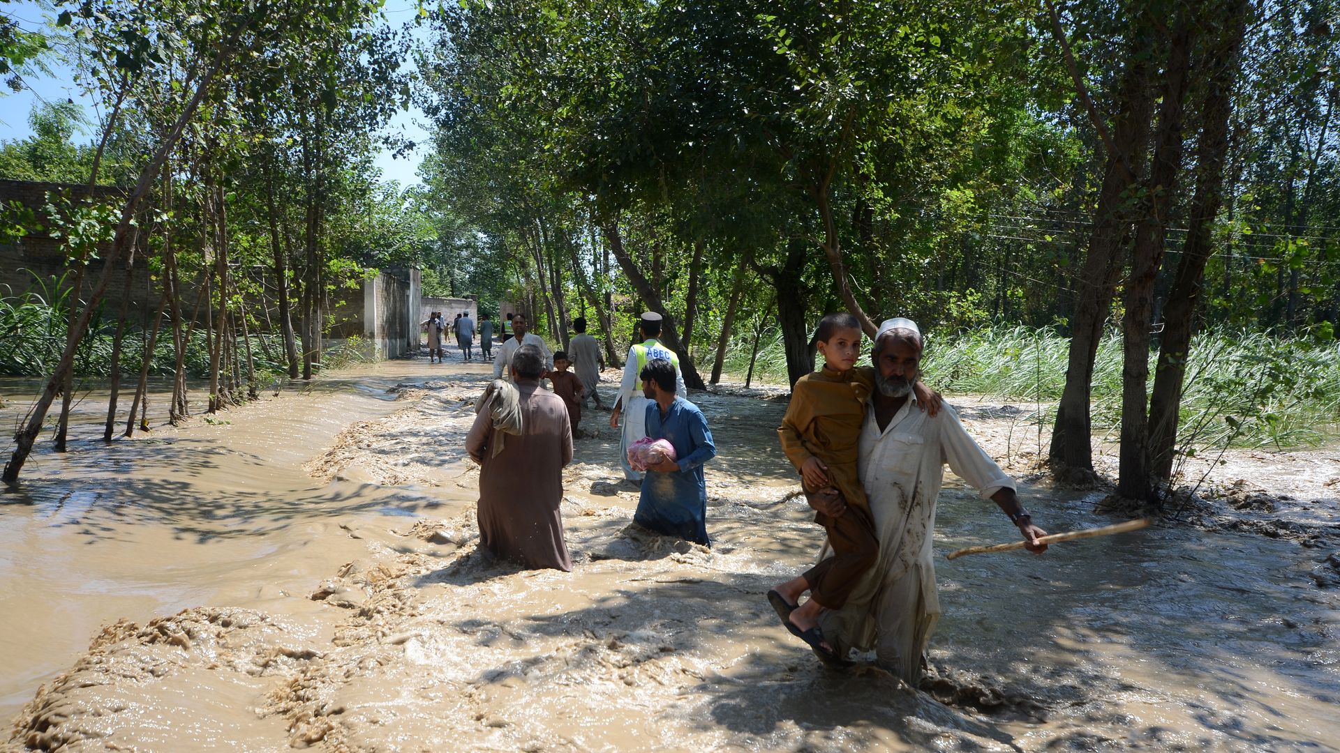 Displaced people wade through a flooded area in Charsadda, Khyber Pakhtunkhwa province, Pakistan on August 28.