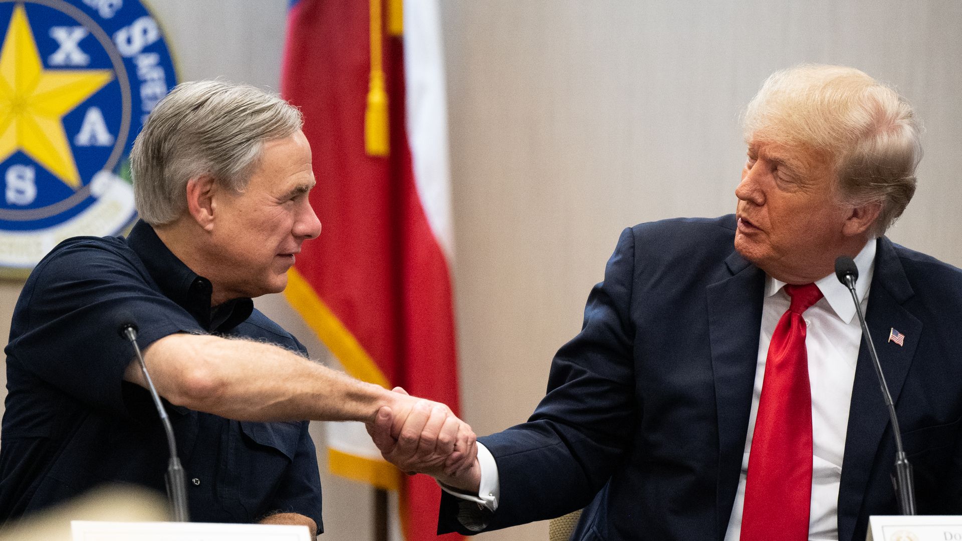 Former President Trump is seen shaking hands with Texas Gov. Greg Abbott during a visit to the U.S.-Mexico border.