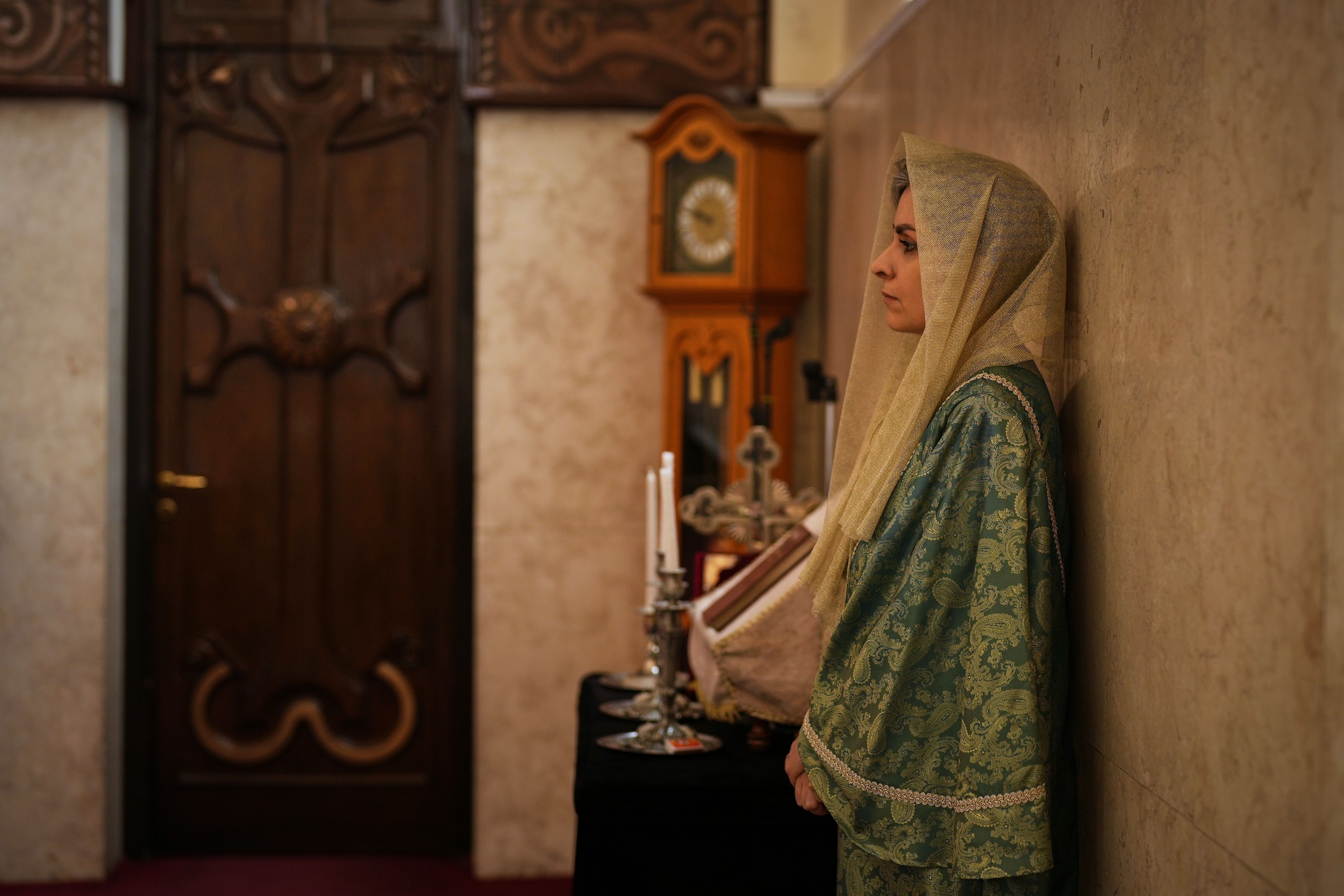 A woman leans on a wall during Easter Sunday Mass at Saint Sarkis Cathedral, an Armenian Apostolic church, in Tehran, Iran, Sunday, April 5, 2026. (AP Photo/Francisco Seco)