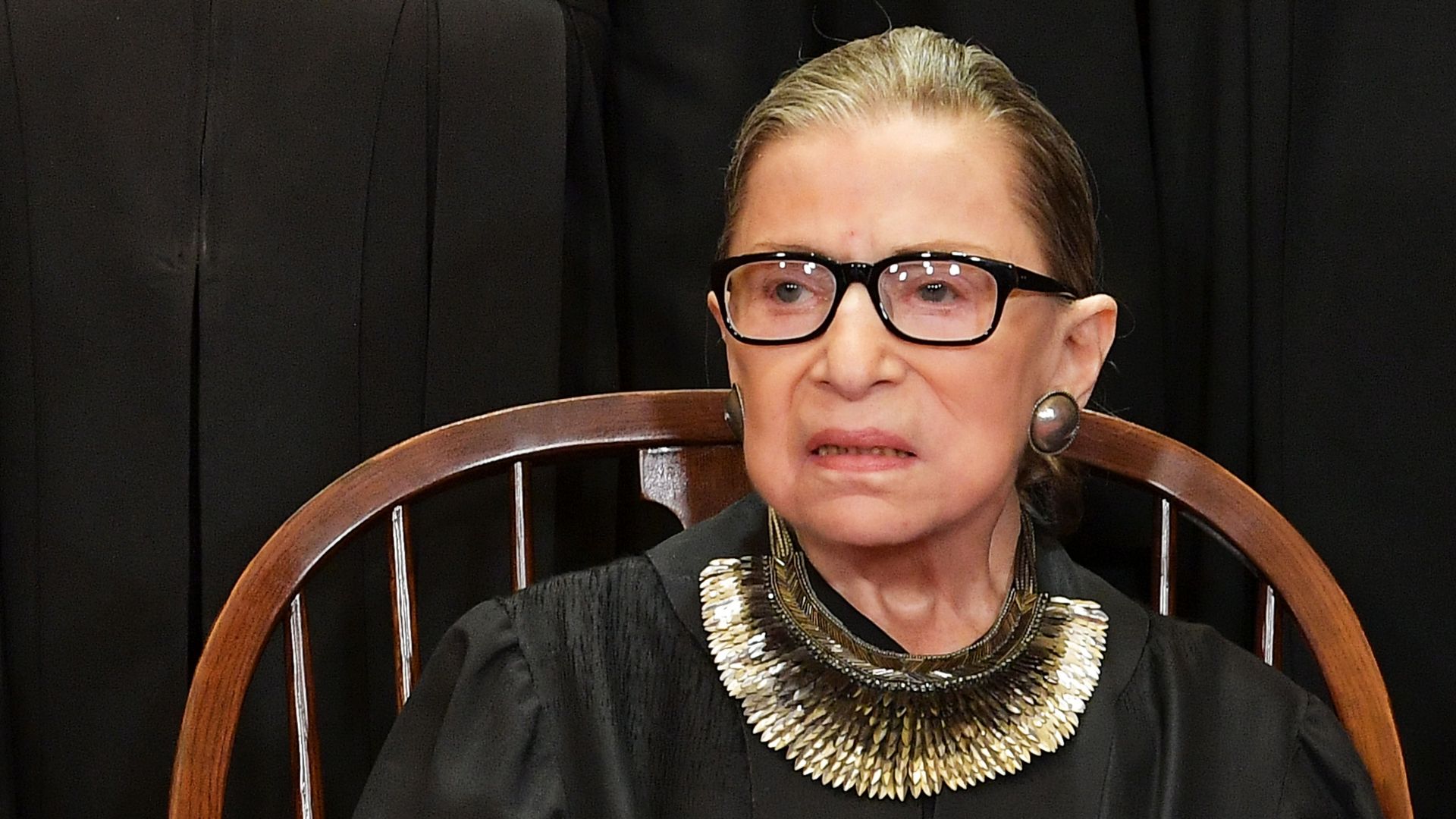 In this image, Ginsburg sits in a chair.