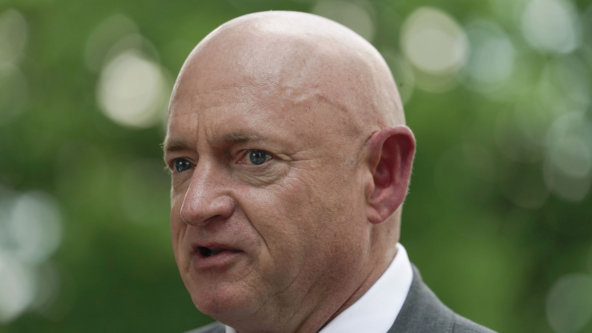 A man in a suit talking.