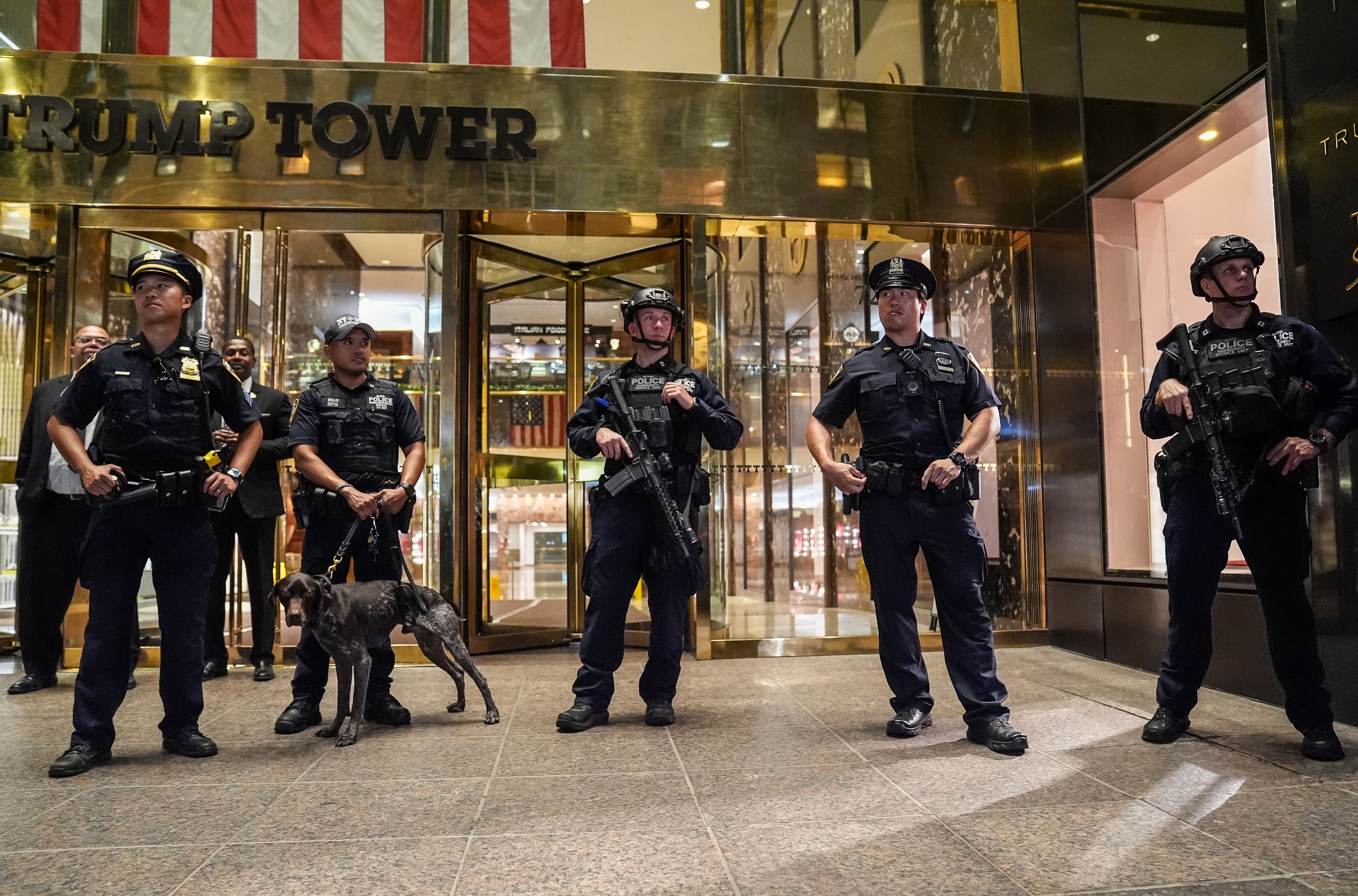 Police standing outside of the entrance to Trump Tower in New York City. 