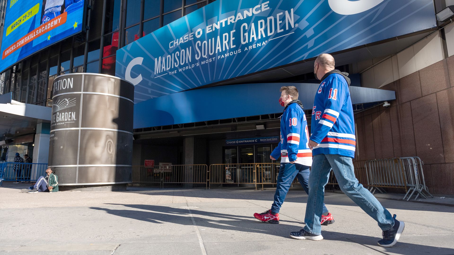 People wearing Rangers jerseys walk past Madison Square Garden on March 30, 2021 in New York City. 