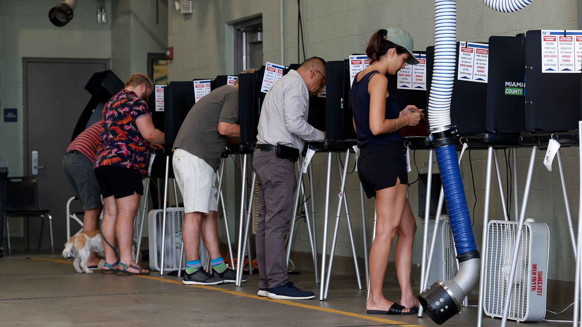 Voters cast their ballots at a polling station setup in a fire station on August 23, 2022 in Miami Beach, Florida.