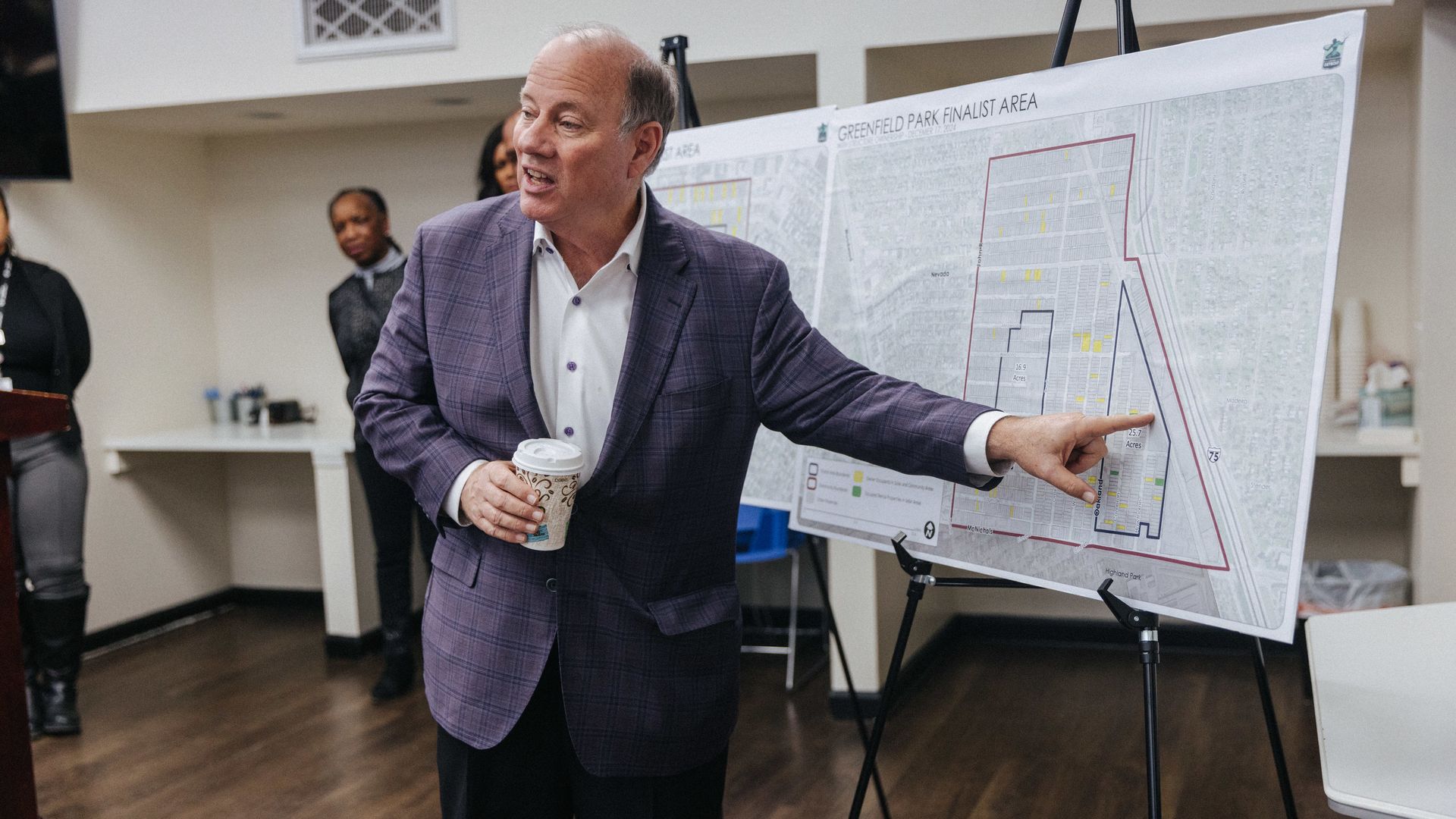 Mayor Mike Duggan speaks in front of a map of one of the solar fields.